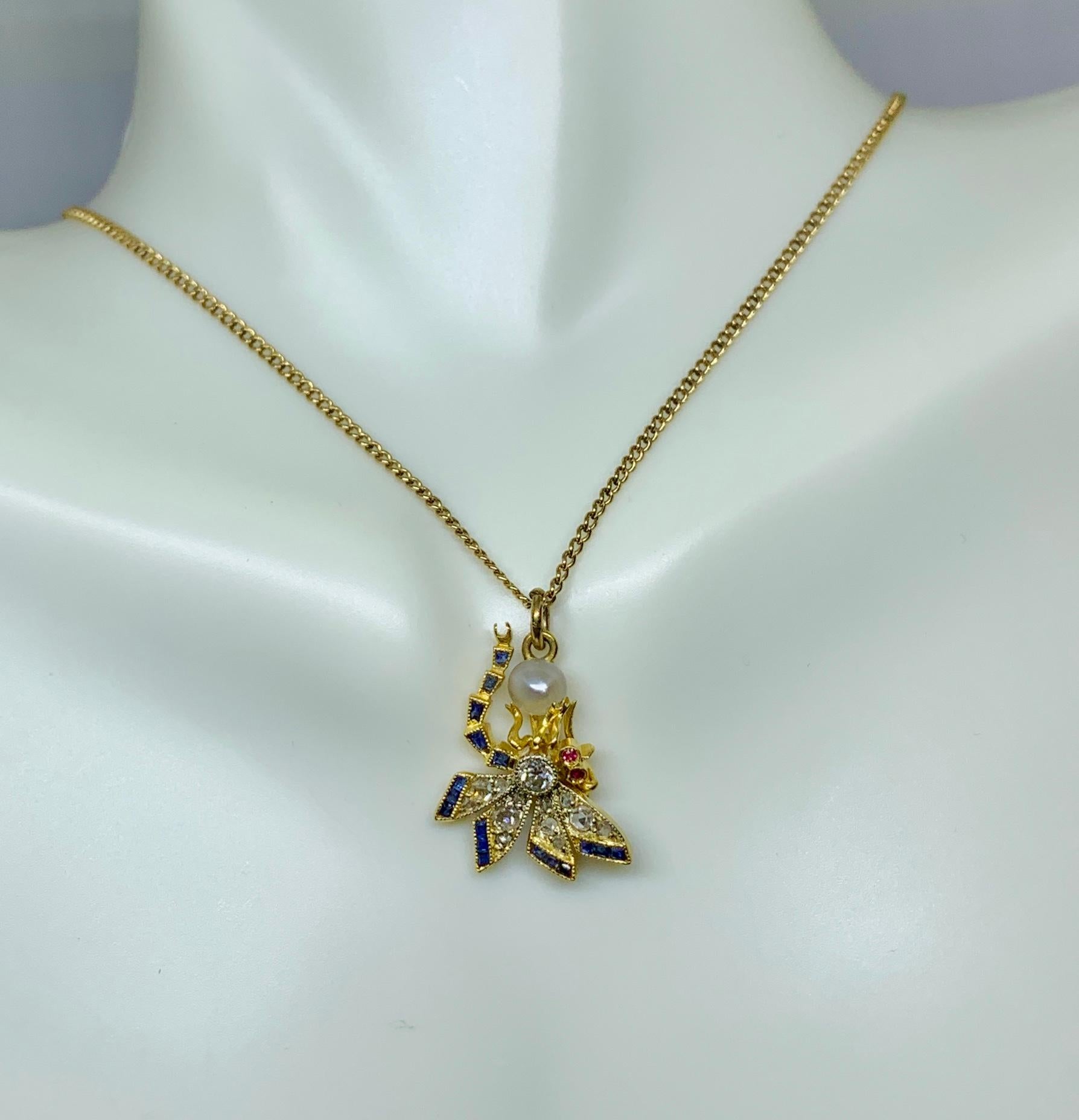 This is a stunning Art Nouveau - Art Deco Rose Cut and Old MIne Cut Diamond, Sapphire, Ruby and Pearl Dragonfly Insect Pendant Necklace and chain in 14 Karat Gold.  The magnificent dragonfly has a central Old Mine Cut Diamond of great beauty.  The