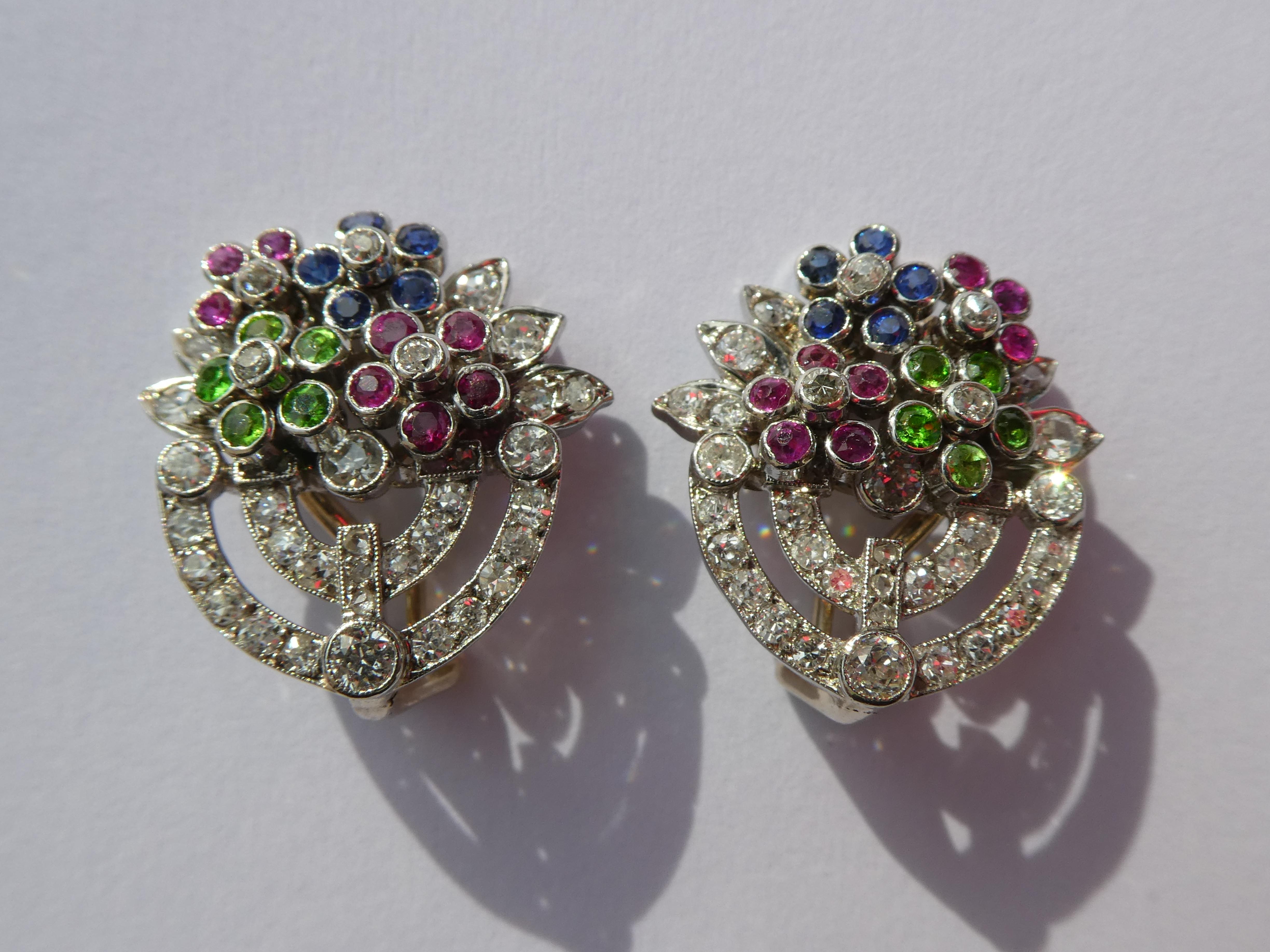 These lovely multicolour flower basket earclips were crafted in platinum in the Art Deco style. The clip on the back is 14 karat white gold. These type of earrings are called Giardinetto which means Little Garden. Giardinetto earrings are quite rare