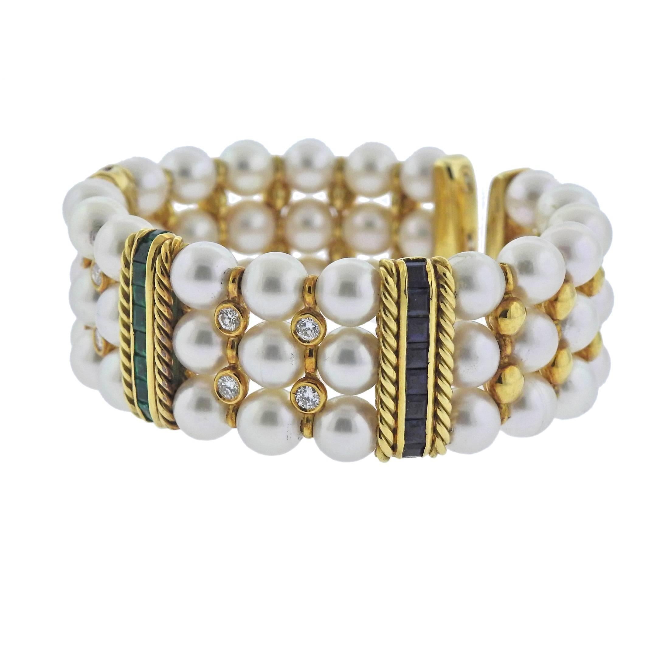  18k yellow gold cuff bracelet, set with three rows of 7-7.5mm pearls, adorned with emeralds, sapphires, rubies and diamonds - approx. 0.80ctw VS-SI/H. Bracelet will fit approx. 6.75-7