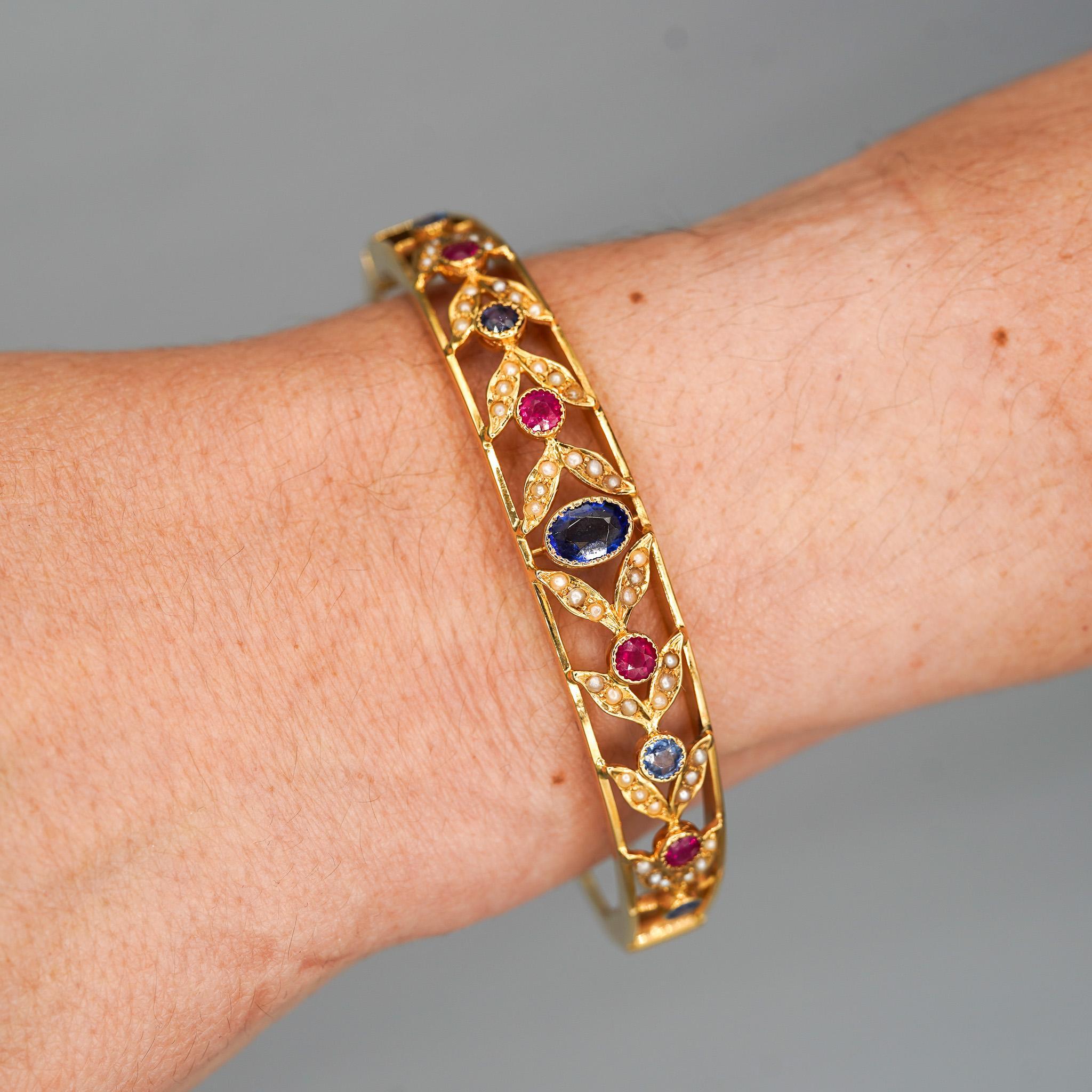 Art Nouveau Sapphire, Ruby, & Seed Pearl 14K Gold Openwork Bangle Bracelet For Sale