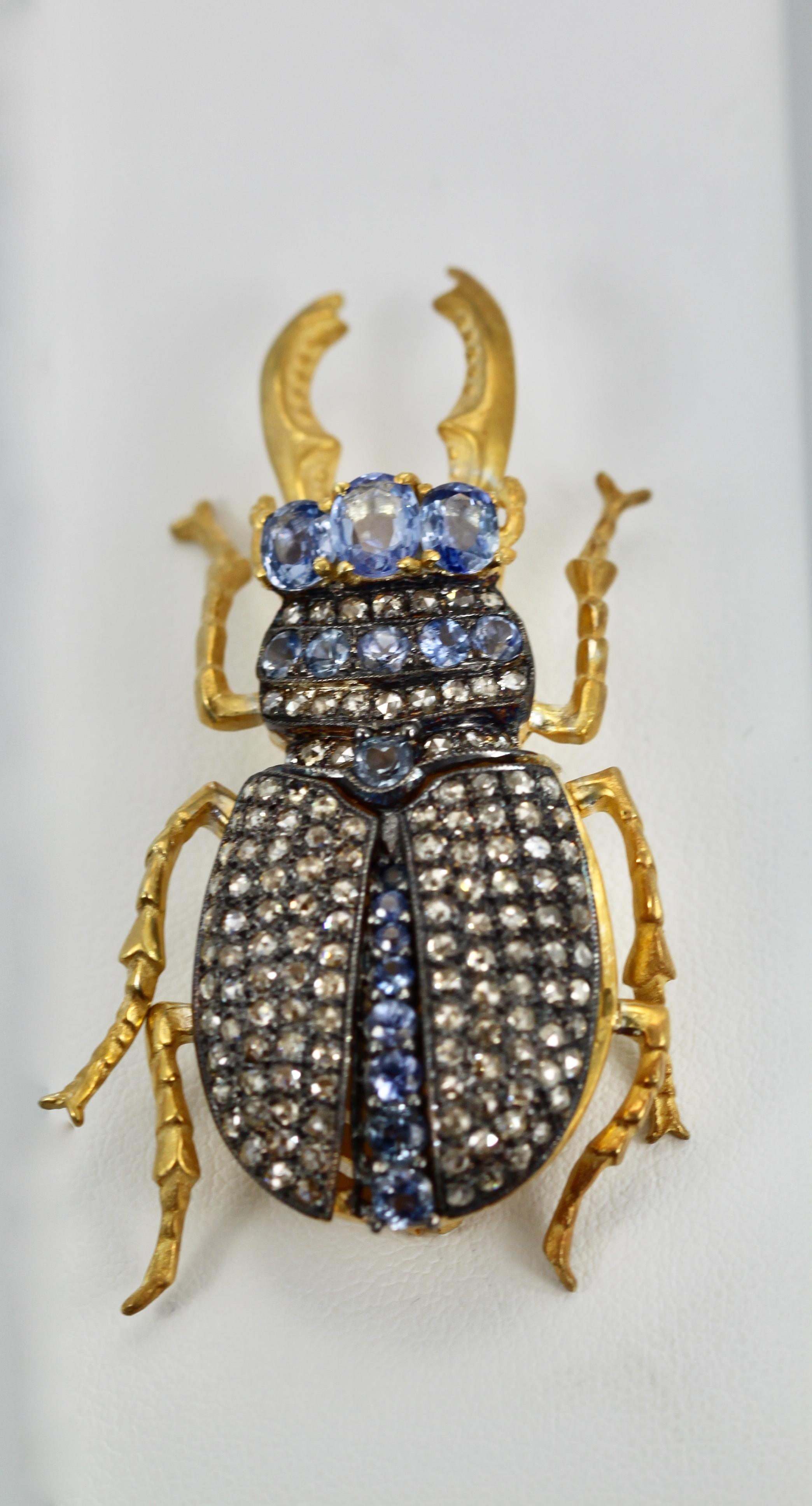 This lovely vintage Scarab Pendant Brooch has 3 large Sapphire stones form the head (approx. 0.40 each.
There are also 5 Sapphires form the throat and a row of Diamonds and Sapphire neck, center body is Sapphires, the body of this beetle opens up