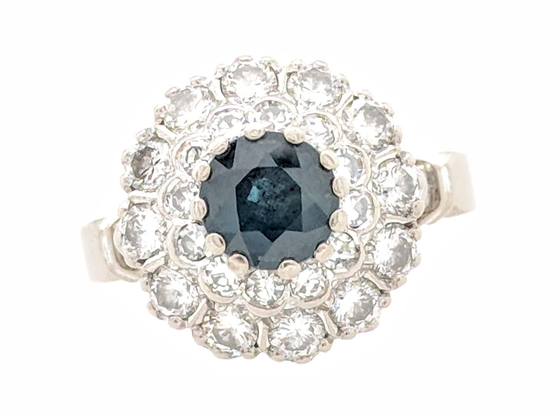 You are viewing a beautiful sapphire and diamond estate ring. Any woman would love to add this piece to their collection!

This ring is crafted from 18k white gold and weighs 6.6 grams. It features one approximately 1ct round sapphire, 12 .03ct