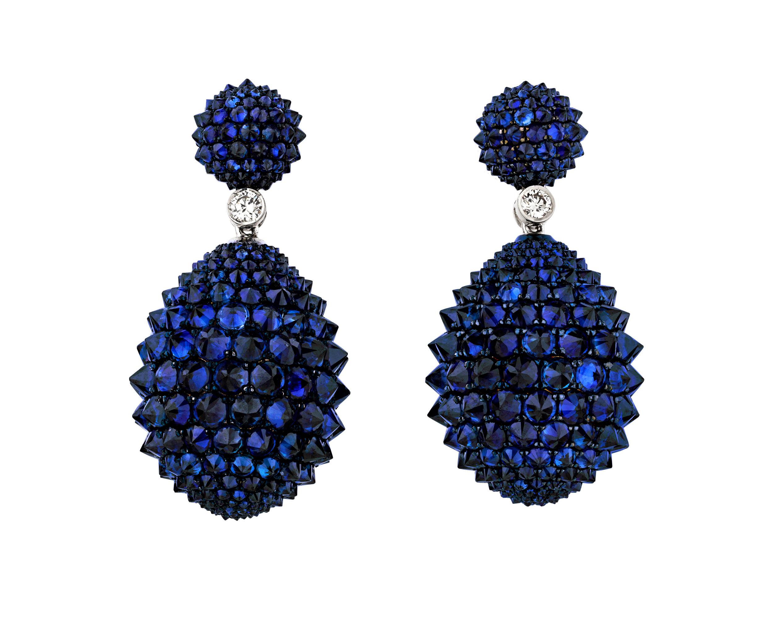 Brilliant sapphires lend an air of luxury to these statement-making earrings. Dozens of sapphires give the earrings their deep blue color while white diamond accents and a bold spiked design brings an unexpected modernity. Set in 14K white gold.

1
