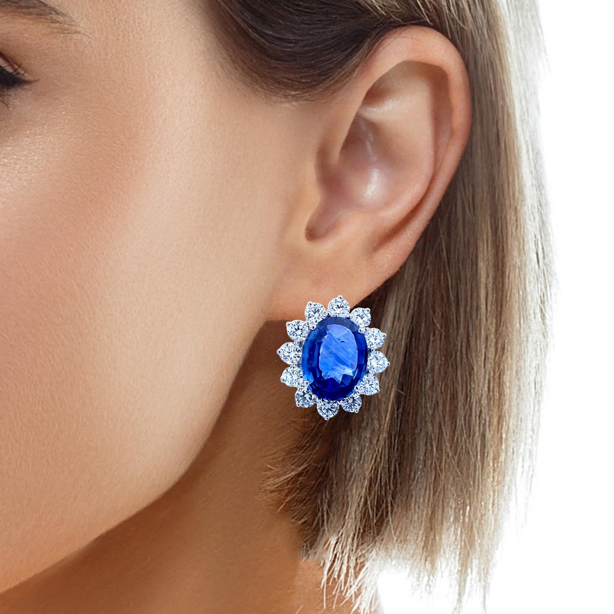 Illuminate your look with these exquisite Sapphire Sunburst Earrings, featuring radiant oval-cut sapphires encircled by halos of sparkling diamonds. Each gemstone is meticulously set to create an awe-inspiring effect that mirrors the majesty of a