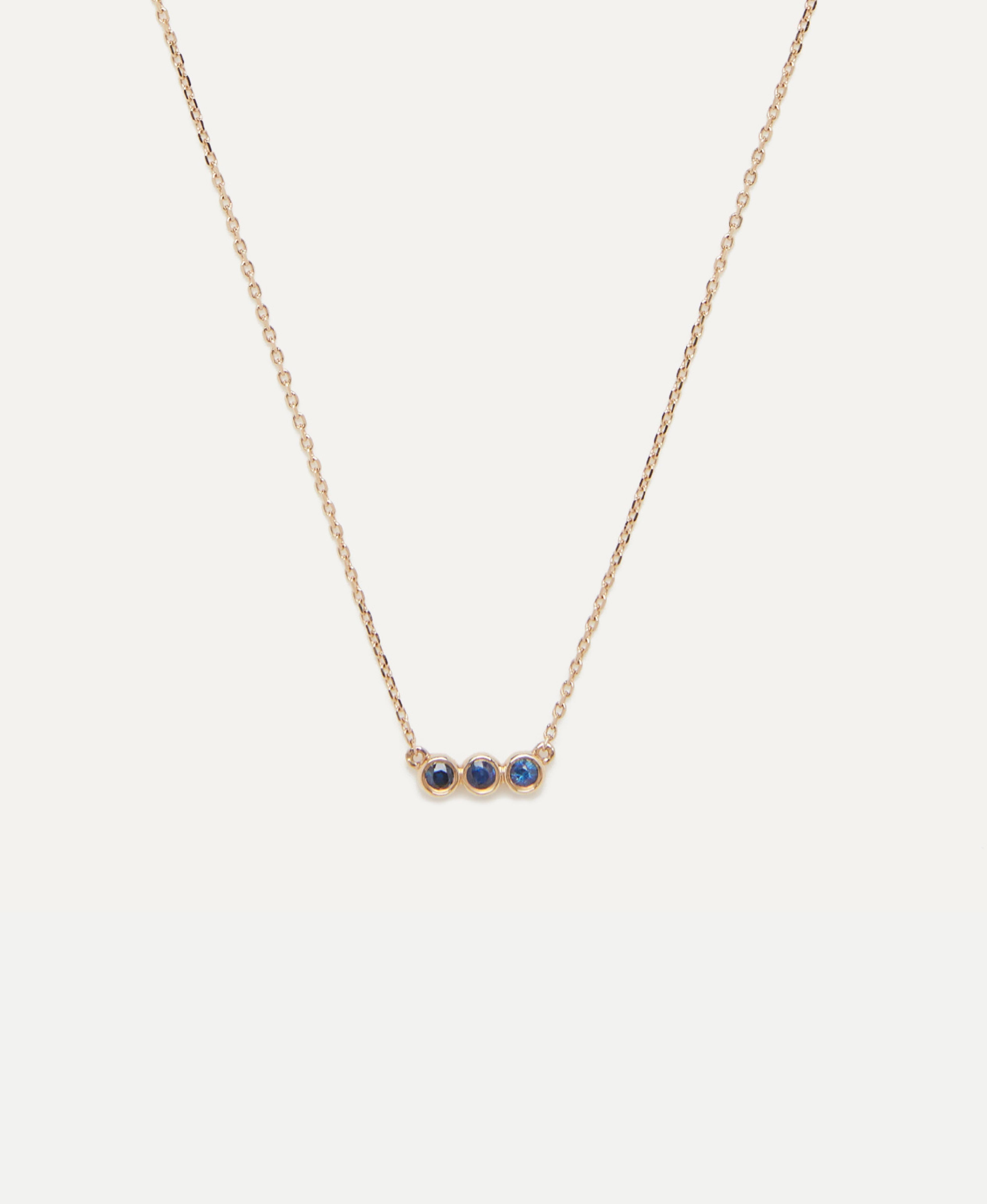 A Sapphire Trio Pendant Necklace is a symbol of timeless beauty and sentimental significance. This necklace features a delicate pendant adorned with three captivating sapphires, deep blue hued. The trio of sapphires represents the past, present, and
