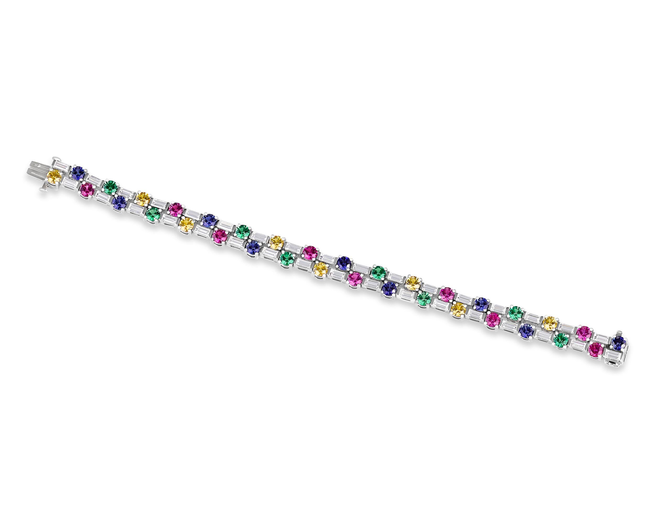 A wonderful collection of colorful round gemstones dot the length of this bracelet from Oscar Heyman. Eighteen pink and blue sapphires totaling 5.38 carats, eight tsavorites totaling 2.19 carats and 8 fancy yellow diamonds totaling 2.35 carats
