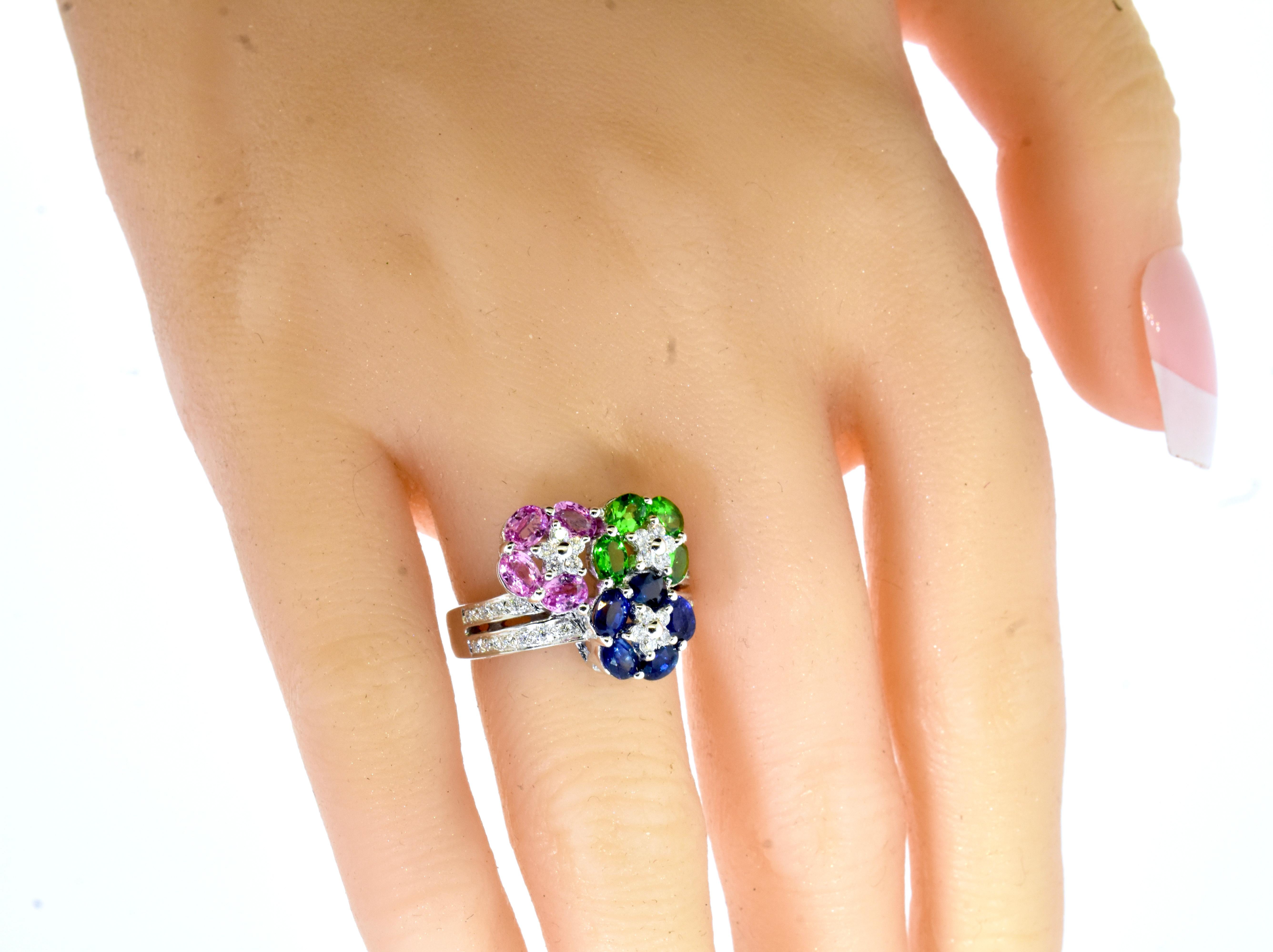 Sapphires, Blue and Pink and bright green Tsavorites with white brilliant cut diamonds all create a very fine contemporary ring by the famous firm of LeVian.  The  fine bright and clean oval cut sapphires (both pink and blue), weigh totally an
