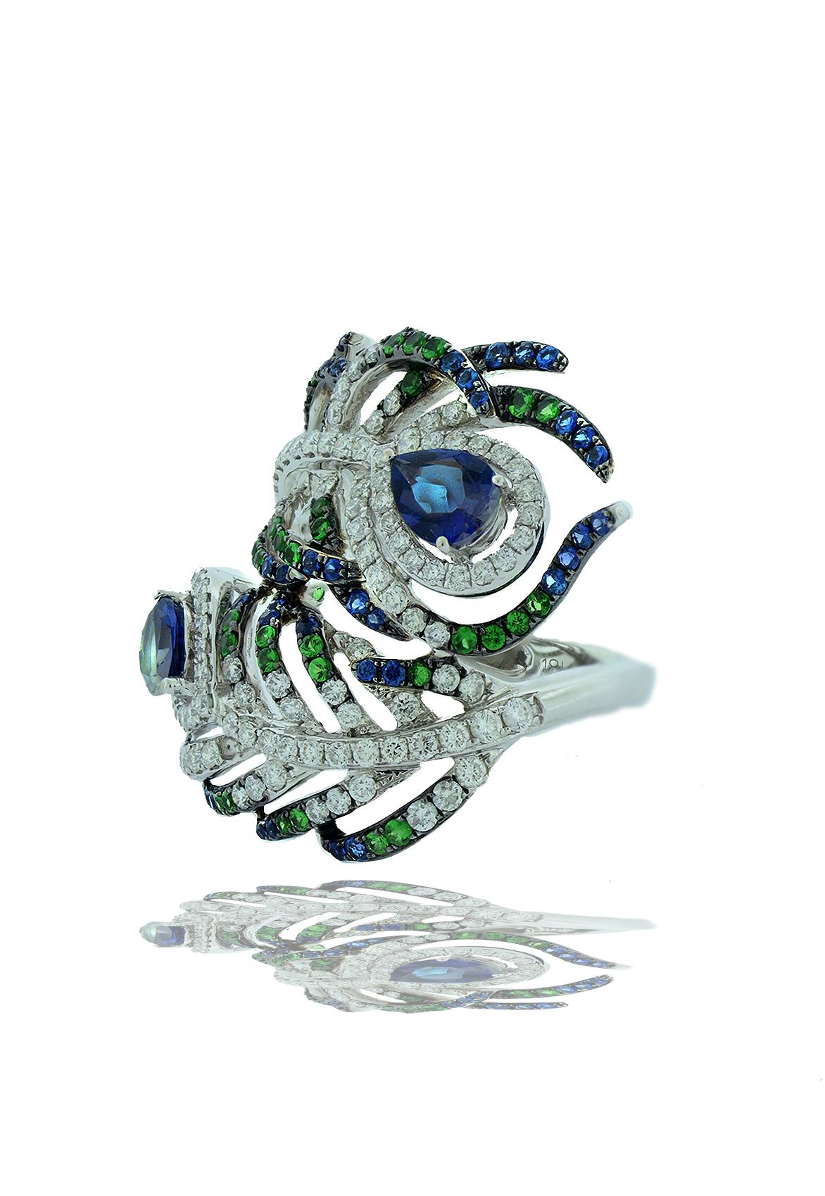 A light hearted and fun ring, this gemstone and diamond ring has the form of peacock feathers.  This ring has 1.2 carats of blue sapphire complimented by .50 carats of electric green tsavorite garnets and 1.5 carats of white F-G-VS-SI.  There are