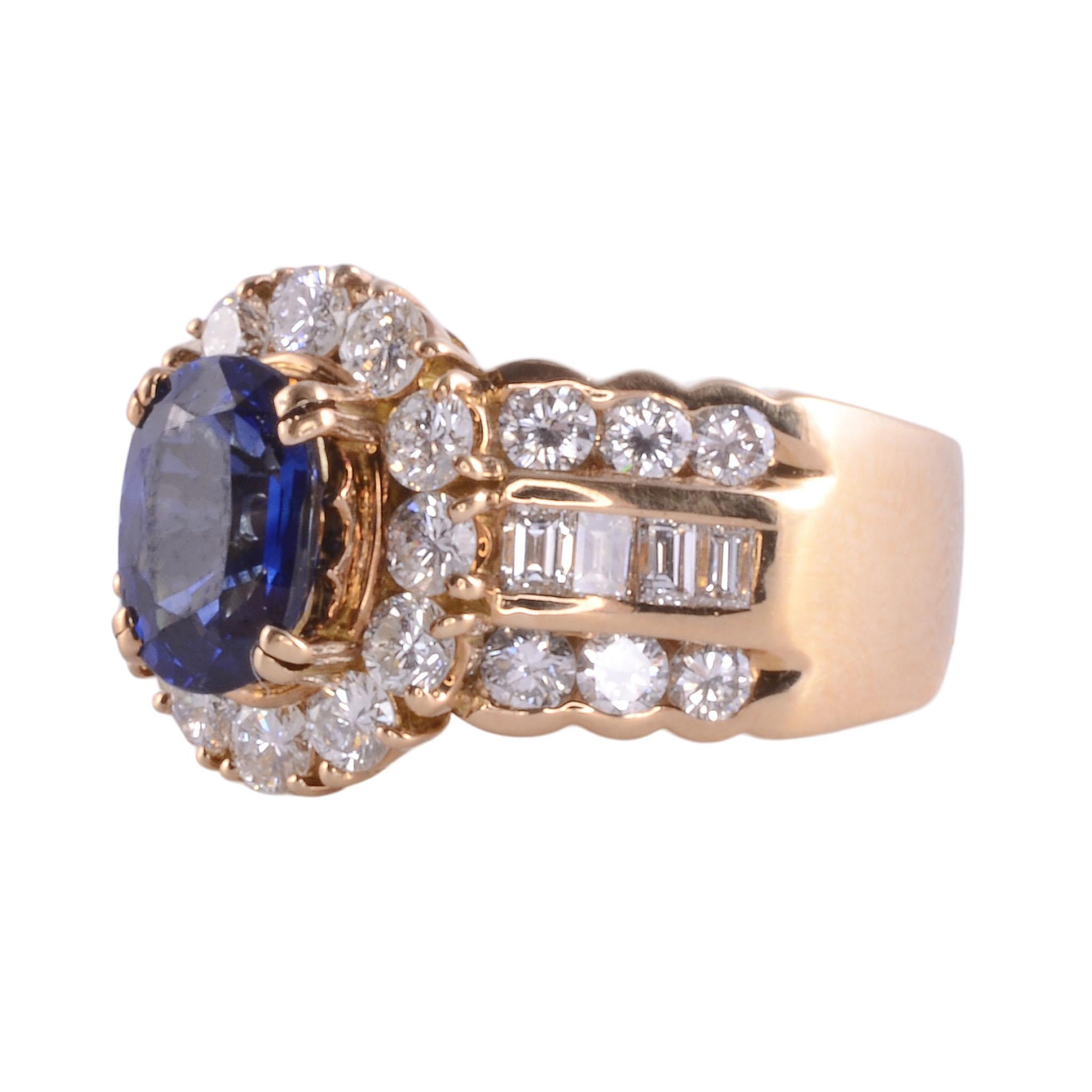 Estate sapphire & VS diamond 18K ring. This 18 karat yellow gold ring features a 1.86 carat oval sapphire center with fine bright blue color. The sapphire is accented with 1.72 carat total weight of round brilliant and baguette diamonds. These fine