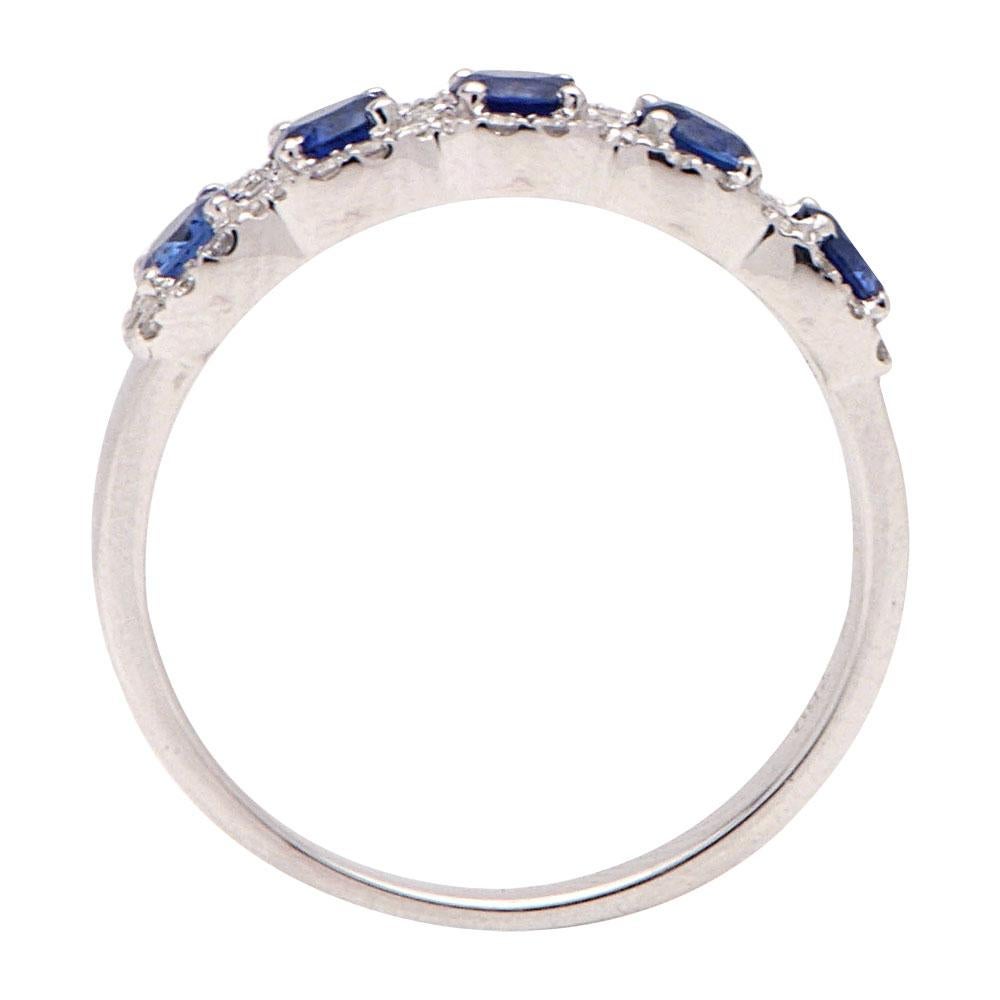 This beautiful band-style ring has 5 round blue sapphires totaling 0.82 carats which are surrounded by 52 round VS2, G color diamonds totaling 0.24 carats which create a beautiful halo around the sapphires. This ring is made from 2.4 grams of 14