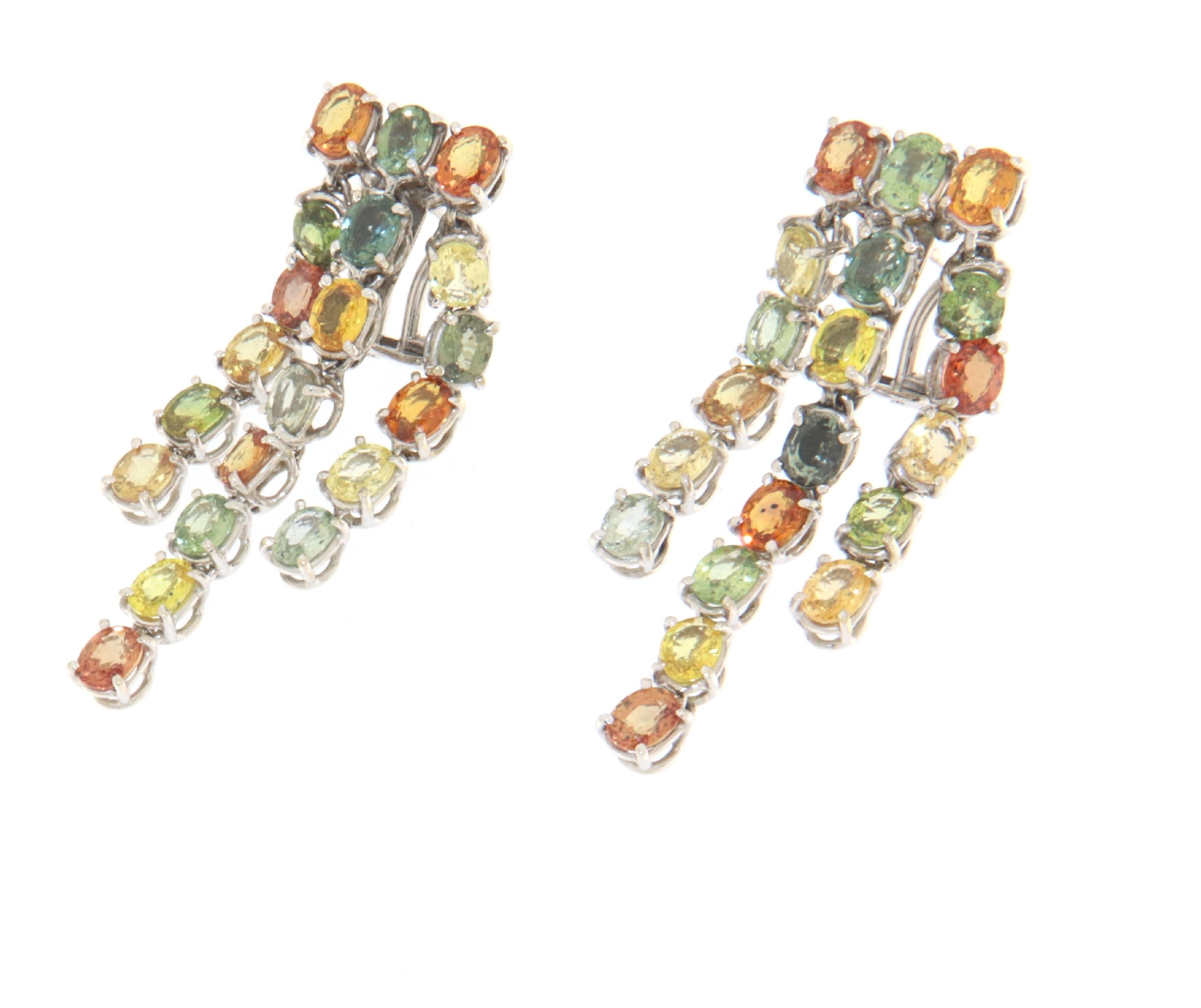 These dazzling 18-karat white gold earrings are a celebration of color and light, featuring a cascade of multi-colored sapphires that sparkle with every turn. The arrangement of the sapphires in a playful, yet elegant waterfall design showcases an