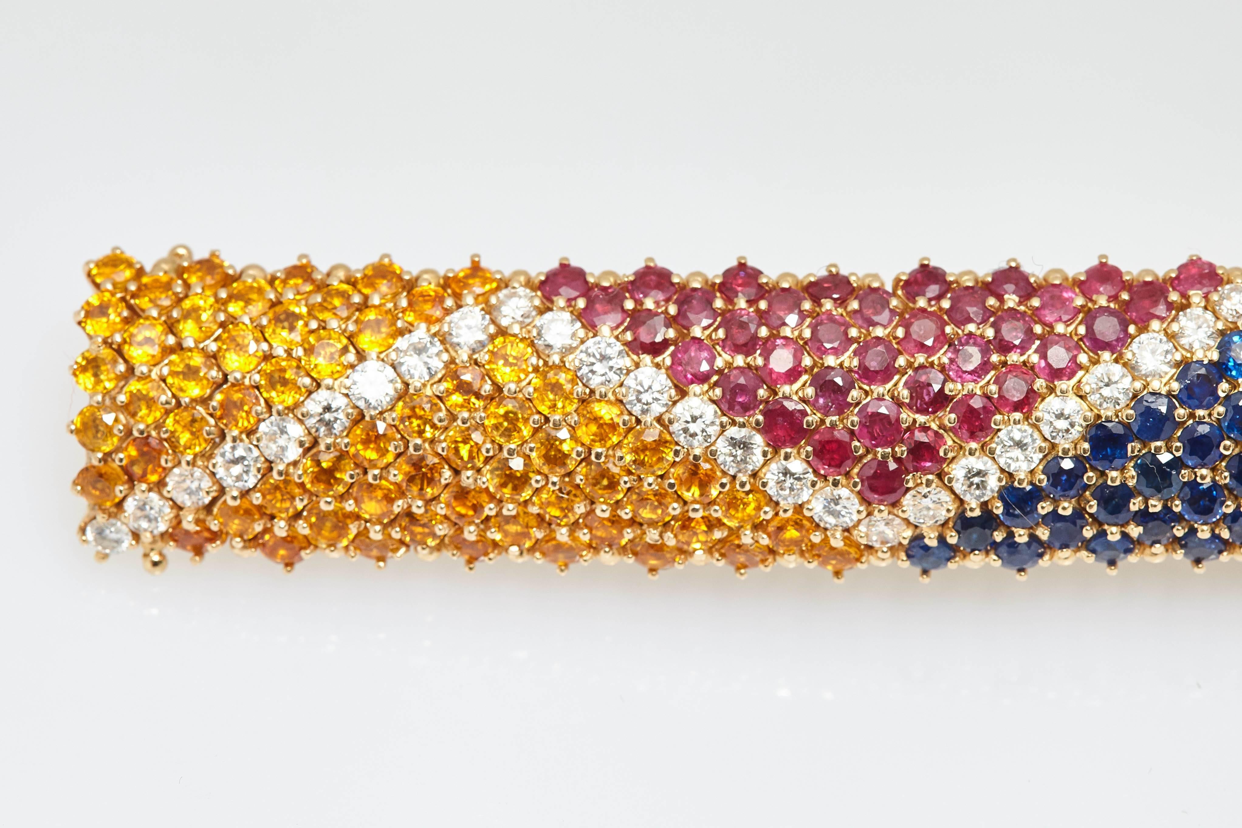 A flexible bracelet in 18kt yellow gold with multi-color sapphires and diamonds. Made in Italy, circa 1980s.