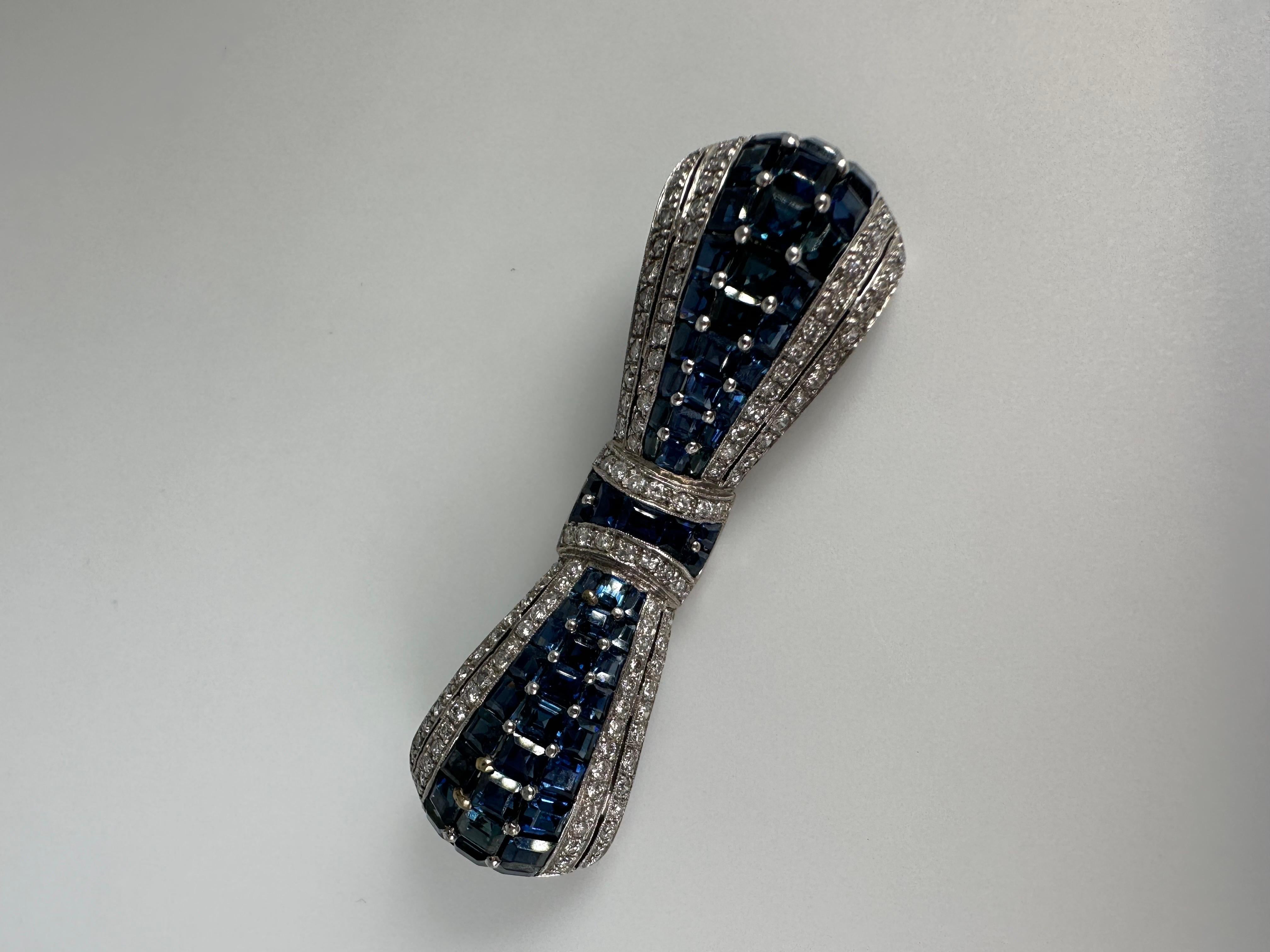 Unique hand crafted sapphire and diamond brooch made in 18KT white gold with stunning royal blue sapphires and fine white diamonds. The brooch is made with 1 carat of diamonds and over 8 carats of sapphires. The total gram weight is 10.18 grams. The