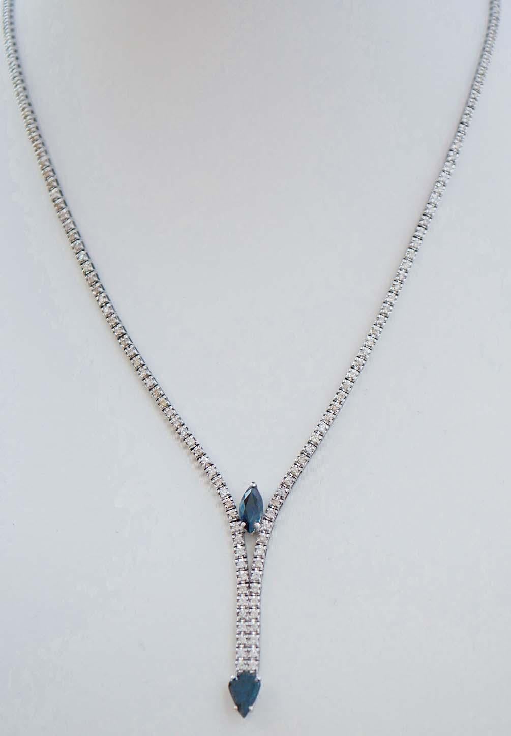 Elegant tennis necklace in 14 kt white gold structure mounted with diamonds for all the lenght; between two rows of diamonds, an sapphire  and, as pendant, a drop sapphire.
This necklace was totally handmade by Italian master goldsmiths and it is in