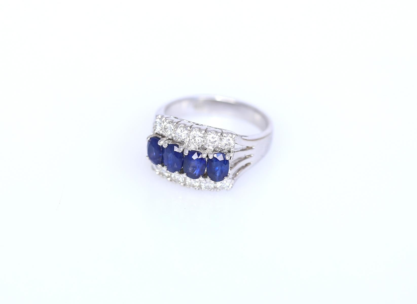 Sapphires Diamonds 18K White Gold Modern Ring. The ring is relatively modern yet the styling is classic and will not grow out of fashion. A line of four oval-shaped deep blue Sapphires is underlined by two rows of fine round-cut Diamonds, six stones