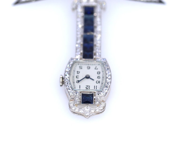 Women's Sapphires Diamonds Onyx Platinum Swiss Brooch Watch Published, 1920 For Sale