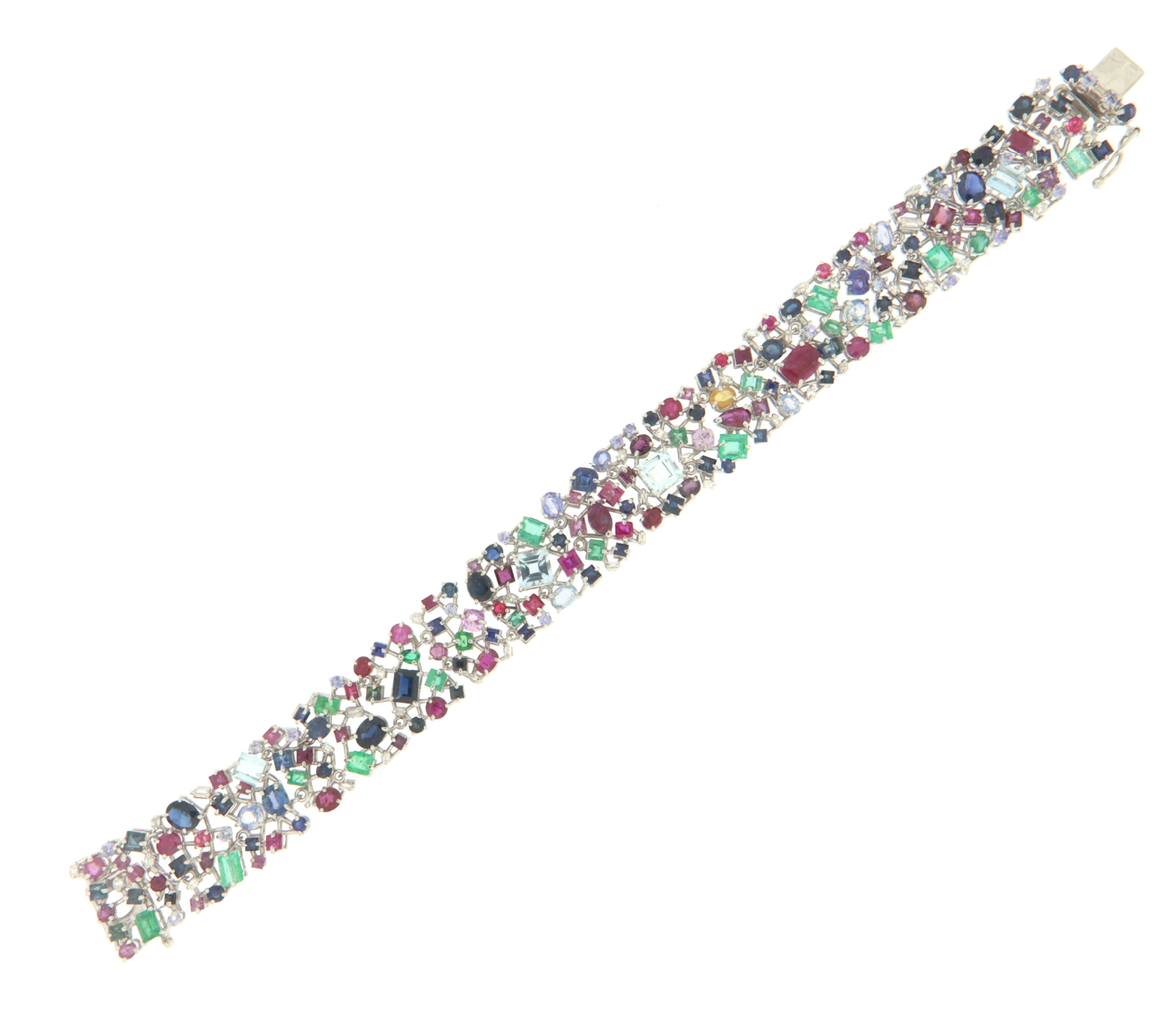 Amazing bracelet made entirely by hand mounted in 18 carat white gold that presents a real storm of colors with all kinds of natural stones, diamonds, rubies, sapphires, emeralds in any type of shape. A jewel to wear on the most important occasions