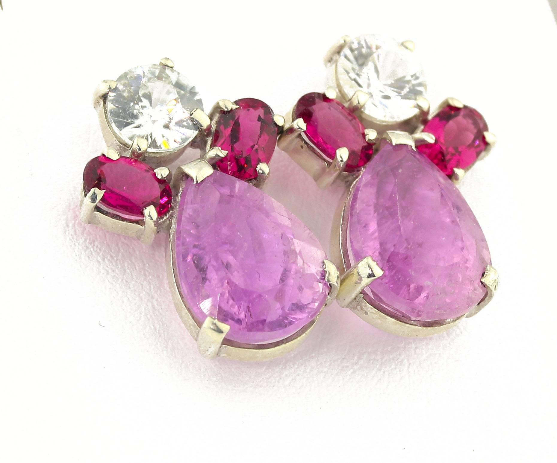 The 4 carats of brilliant red oval Rubelites accent these beautiful round white glittering Sapphires (6 mm) and unique pear cut Kunzites (13 mm x 9.8 mm) in handmade sterling silver stud earrings.  They sit elegantly at approximately .86 of an inch.