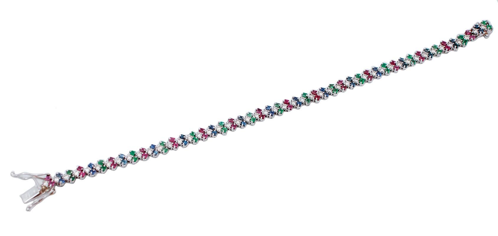 SHIPPING POLICY: 
No additional costs will be added to this order. 
Shipping costs will be totally covered by the seller (customs duties included).

Beautiful bracelet in 14 karat white gold structure mounted with emeralds, sapphires and rubies in