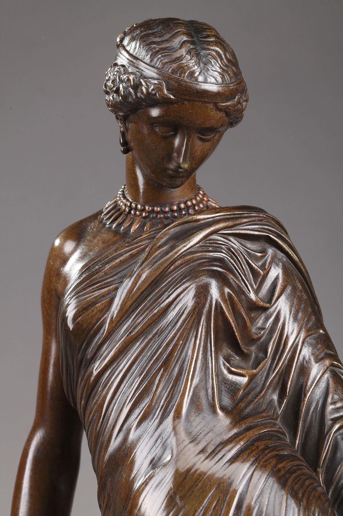 Bronze sculpture with brown patina featuring Sappho after Jean-Jacques, dit James Pradier (1790-1852). The poet wears a beautiful antique tunic and jewels. Sappho is known for her lyric poetry, written to be sung while accompagnied by a lyre, that