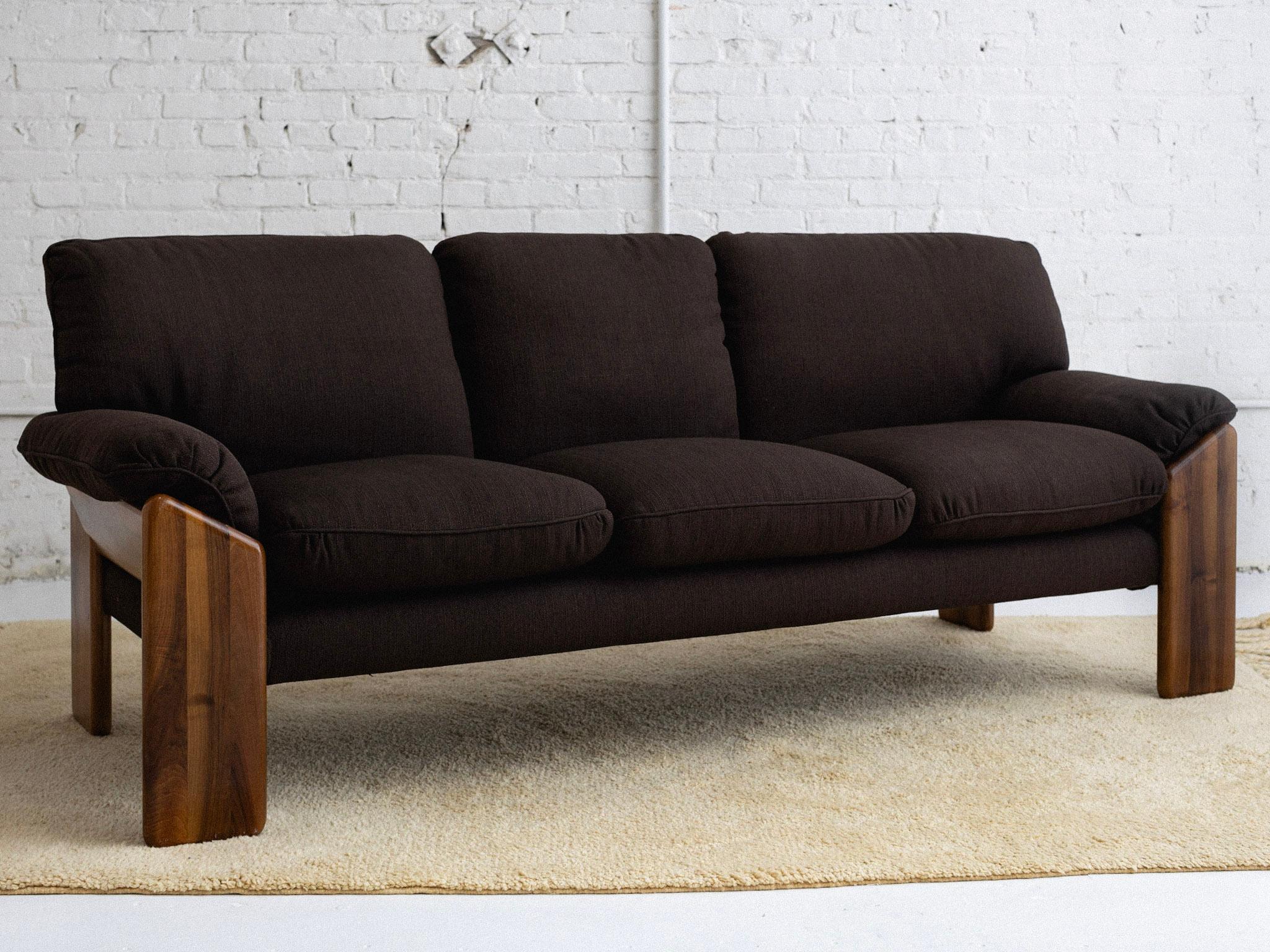 A 'Sapporo' three seat sofa designed by Mario Marenco for Mobil Girgi. A solid wood frame holds eight zipper removable cushions. Reupholstered by its previous owners in a brown woven polyester blend. Stamped “Mobil Girgi.” Sourced in Northern Italy.