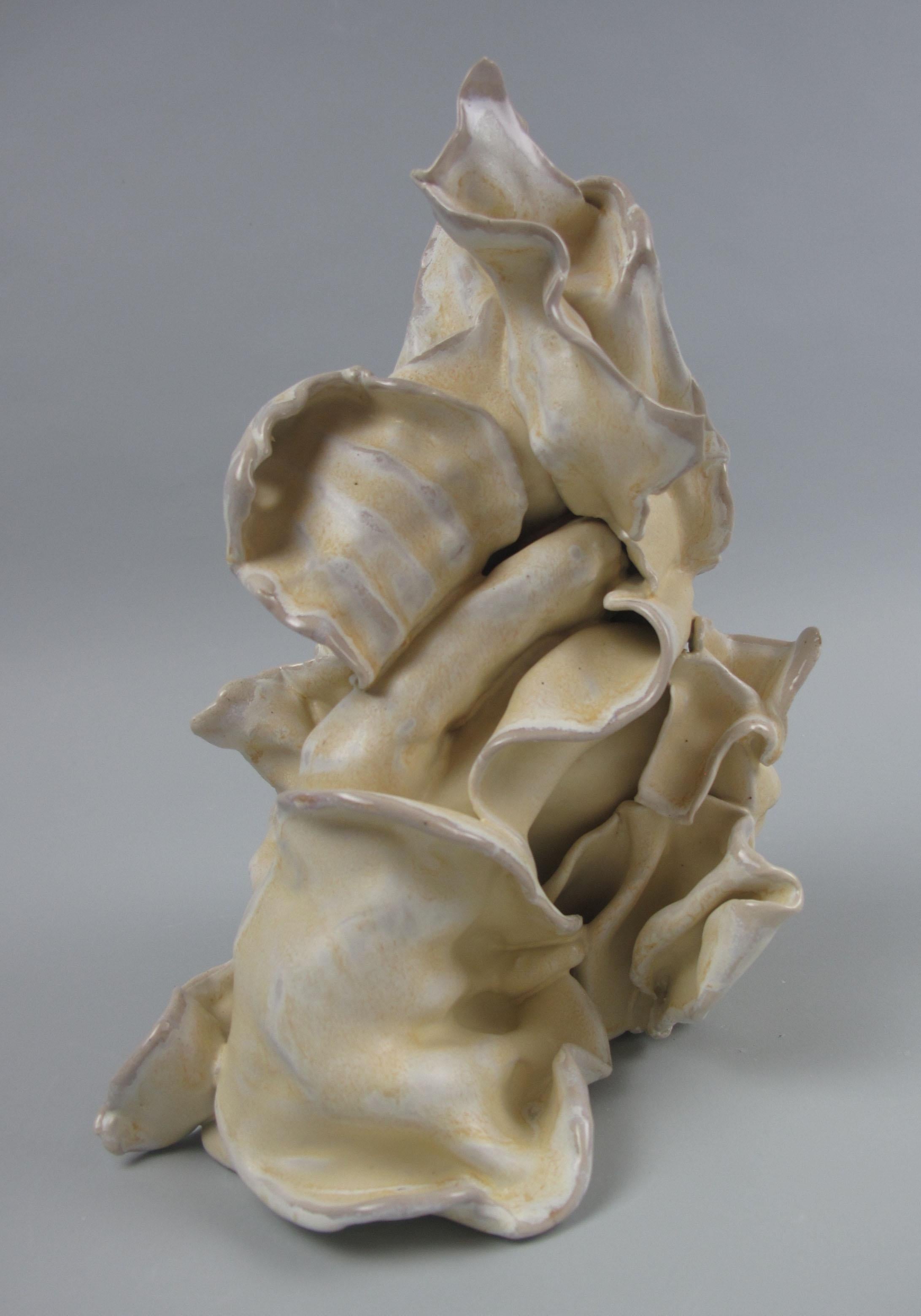 Sara Fine-Wilson's ”Grasp” is a gestural 10 x 8 x 5.5 inch ceramic sculpture in pale yellow with accents of cream, white and tan. In this graceful and evocative sculpture individual slab elements are assembled, layered in glaze and soda fired. This