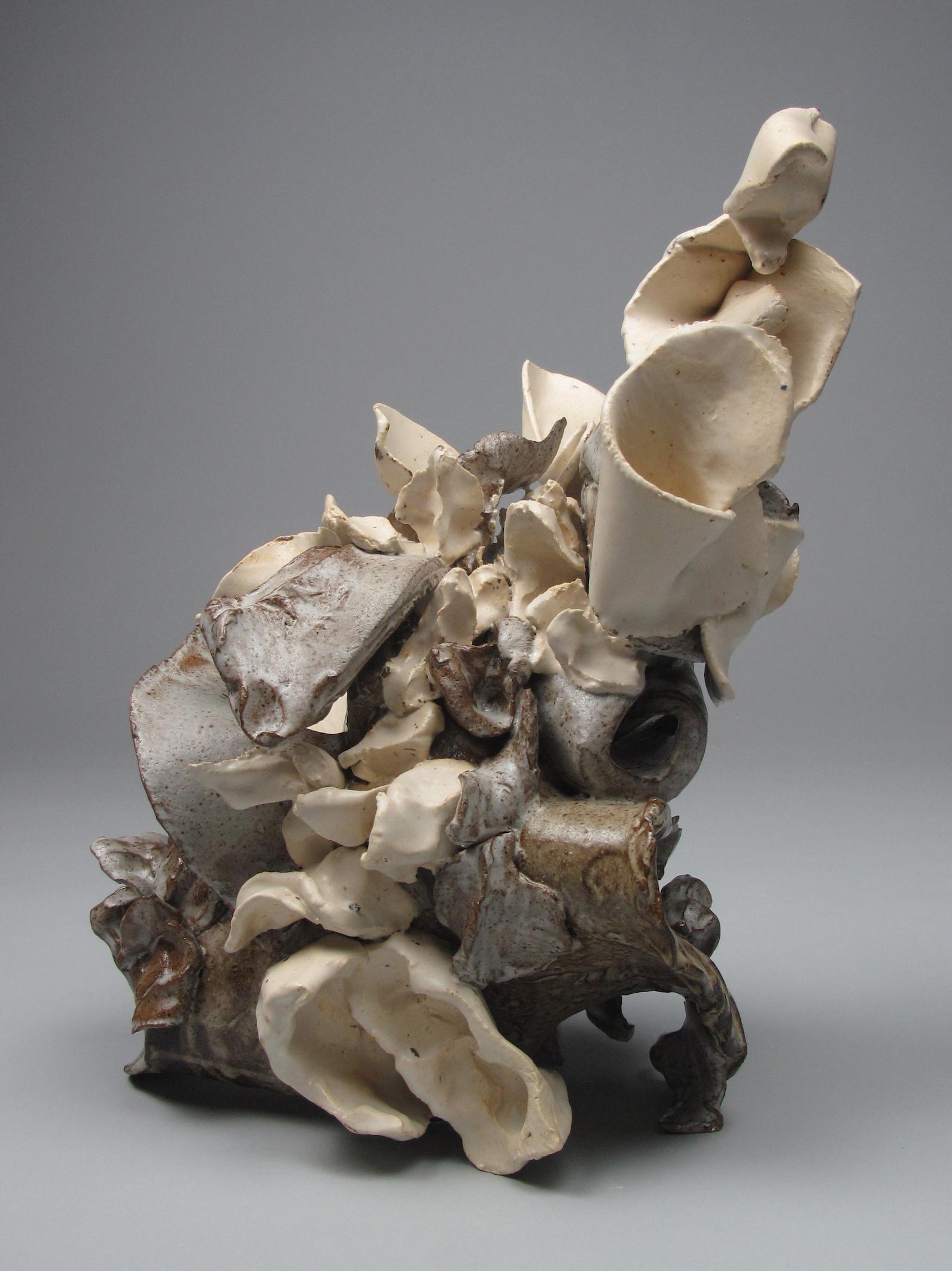 Sara Fine-Wilsons ”Milky Jumble” is a gestural 12.5 x 10 x 8 inch ceramic sculpture in shades of brown, white and cream. In this powerful and evocative sculpture individual slab and pinched elements formed from multiple clay body types are assembled
