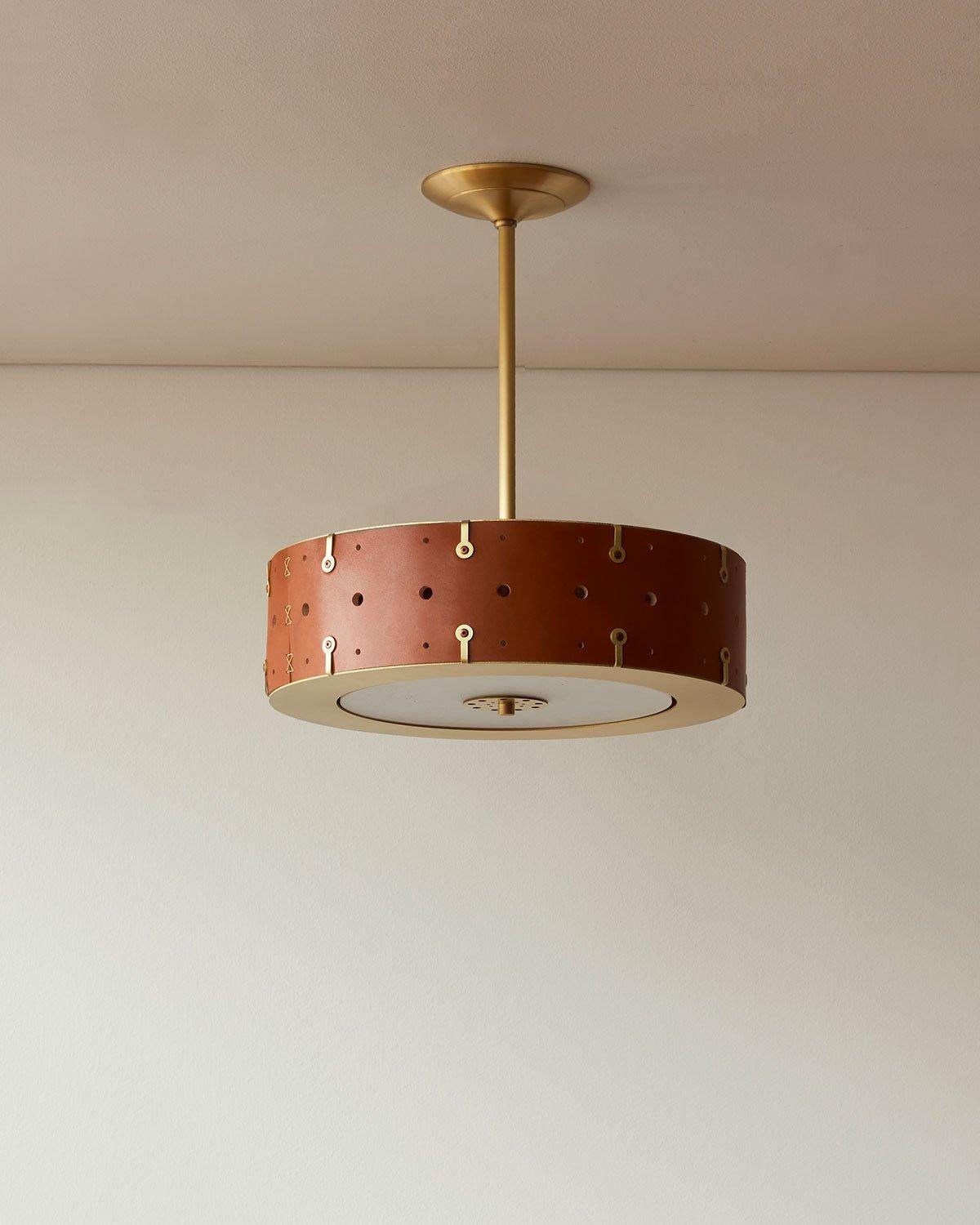 Composed of a hand-sewn leather drum fitted between a satin brass top and bottom ring, the Sarah can be customized with the drop height that is right for your space and the pipe can be removed altogether to create a flush-mount fixture. A thin white