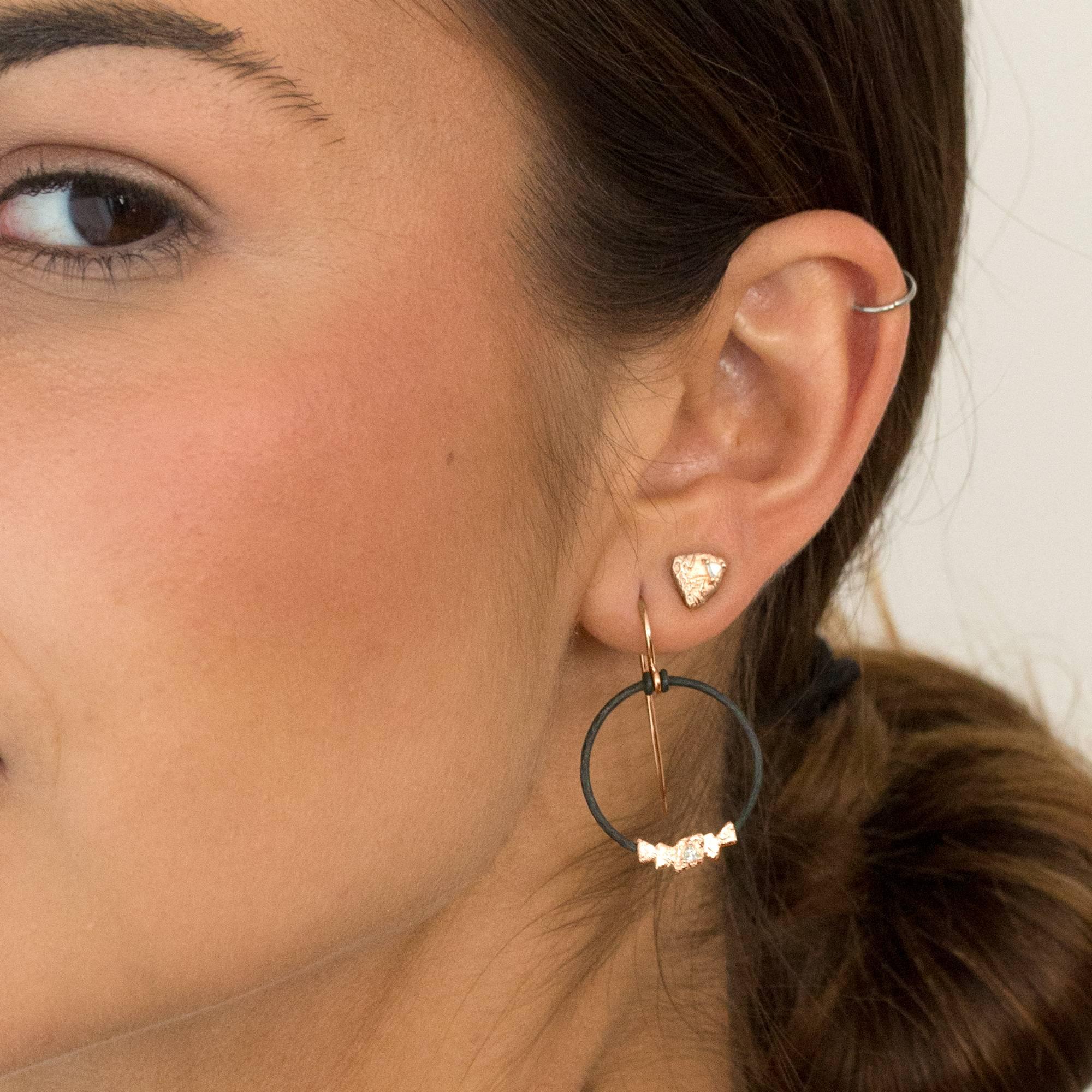 Trigon Stud Earrings handcrafted by jewelry designer Sarah Graham featuring 0.10 total carats of trillion-cut white diamonds set in beautifully-textured 18k rose gold inspired by both the natural beauty of Colorado and the unusual and remarkable