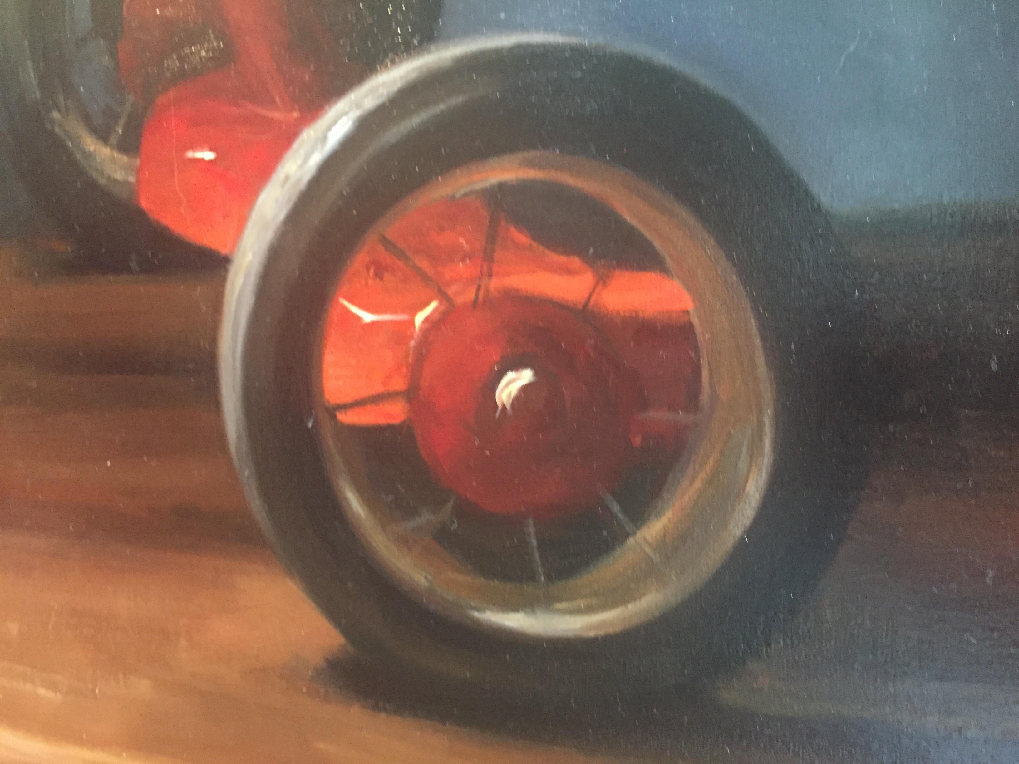 A traditional oil still life painting. In the style of classical realism, or poetic realism. 

An old red trike, or tricycle, is the subject of this oil painting.  Placed atop a wooden surface, lit from above in a dark, trimmed doors.

Framed