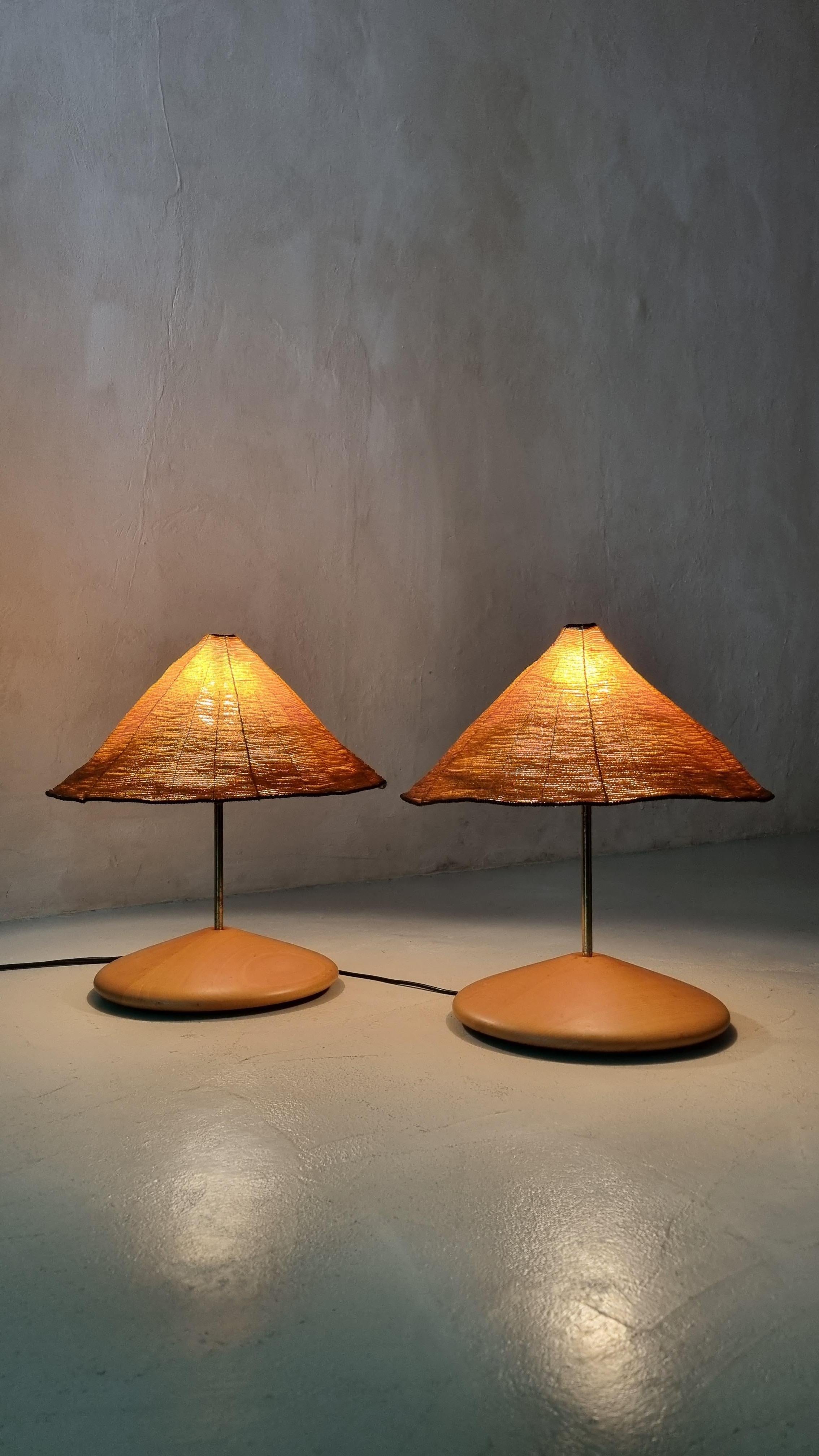 Rare pair of table lamps mod. Sarasar designed by Roberto Pamio and Renato Toso for Leucos in 1975.
Polished wood base, diffusers in colored glass beads, amber and black edge, painted metal structure. This rare pair of lamps was produced only for a