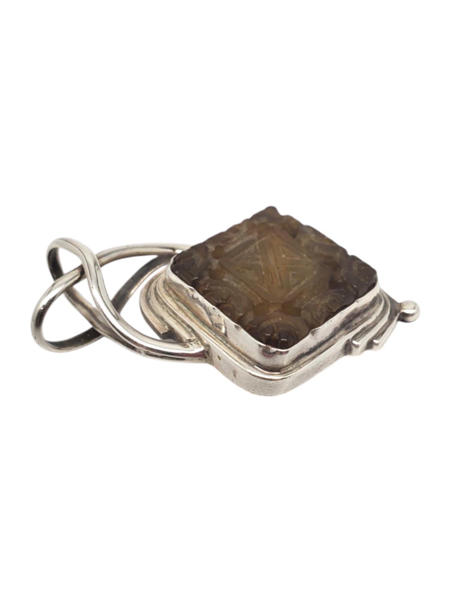 Sarda Sterling Carved Smokey Topaz Pendant -

This unique pendant features a carved design smokey topaz (27.08 mm x 26.62 mm) in classic sterling silver by Sarda.

Size: 51.63 mm x 30.24 mm

Stamped: 925 SARDA

Weigh: 11.5 dwt / 18.02 gr

*Chain not