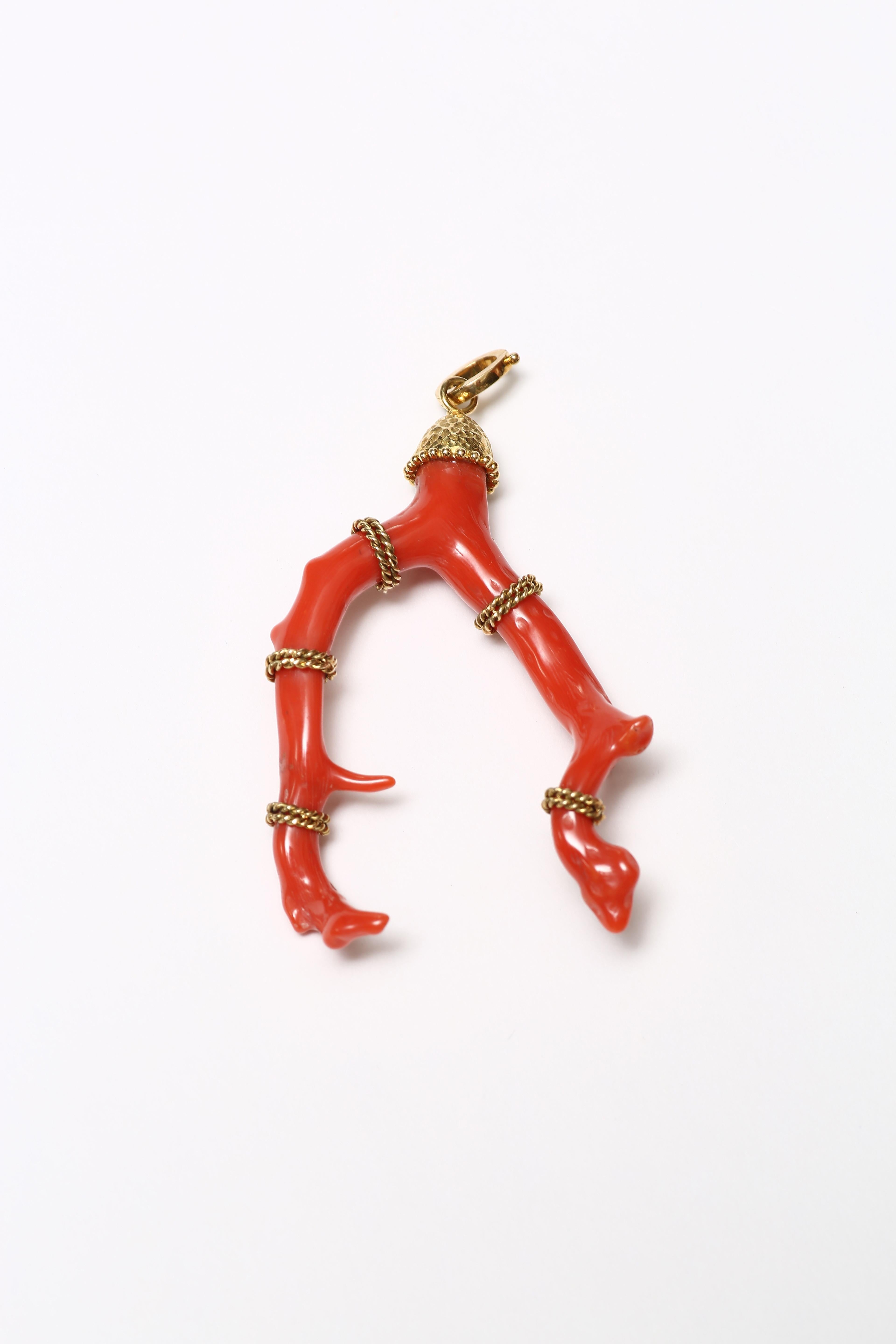 A handcrafted Sardinian branch coral pendant wrapped with twisted 18 karat gold rope. It comes with a top opening clasp to enable it to be hung on necklaces.

A beautiful example of a classic coral branch pendant, the arms wrapped in 18K twisted