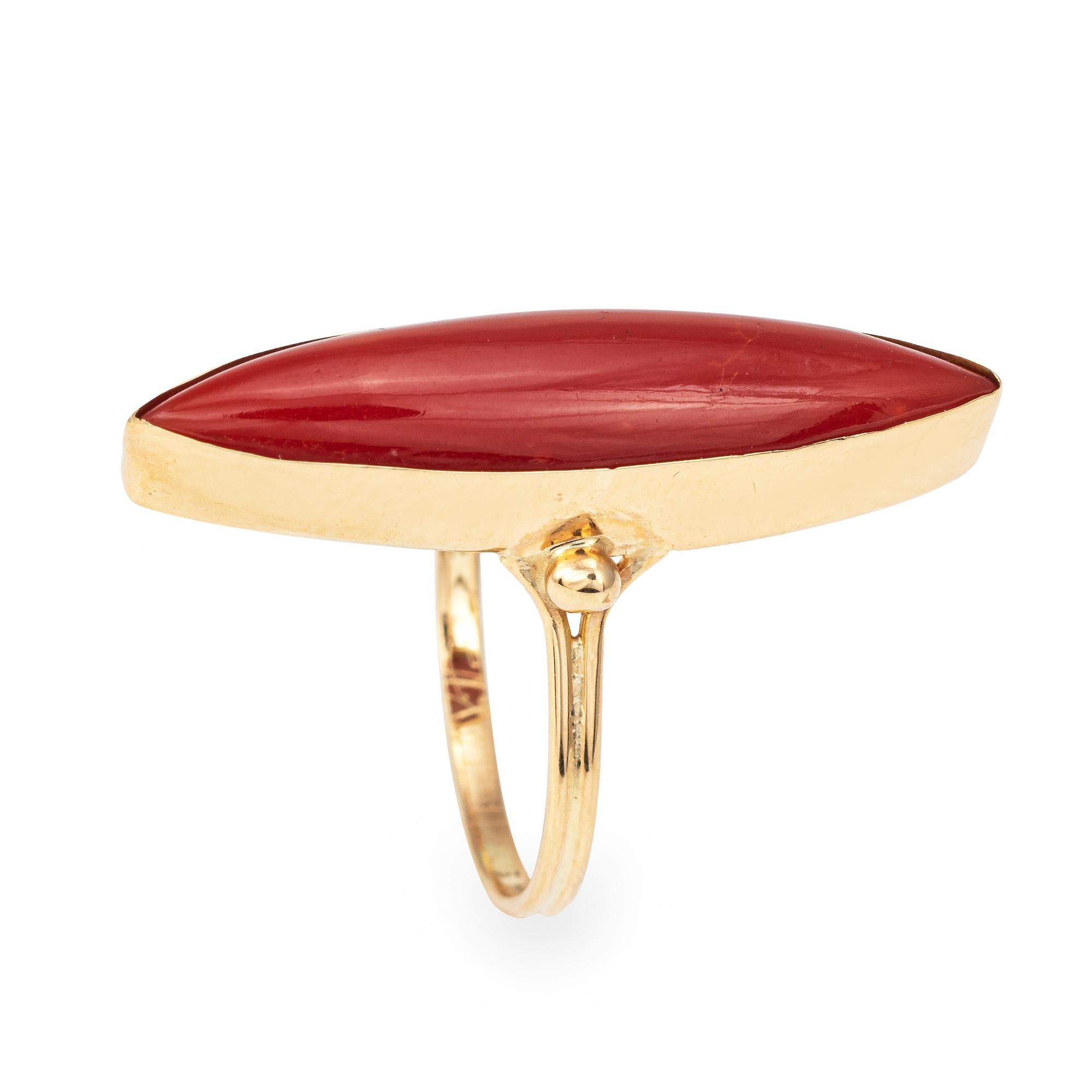 Stylish vintage Sardinian red coral navette ring (circa 1950s to 1960s) crafted in 18 karat yellow gold. 

Sardinian red coral measures 27mm x 6mm. The coral is in good condition and free of cracks or chips. 

The elongated navette mount highlights