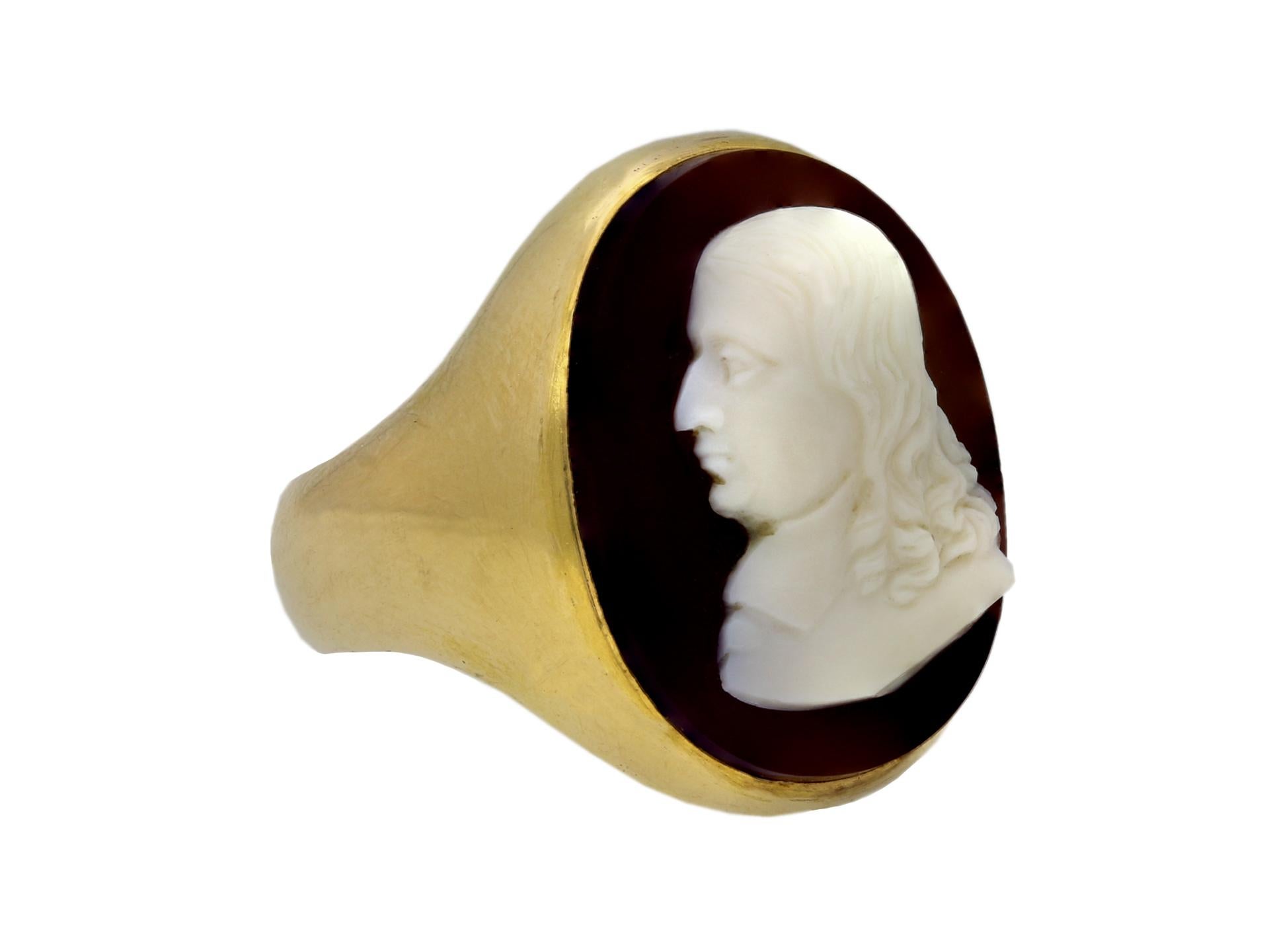 Stuart sardonyx cameo of John Milton mounted in a Victorian gold ring. Set with an oval sardonyx 17th century cameo in a rubover setting featuring a profile bust of John Milton (1608-74), the eminent seventeenth century English poet, leading to