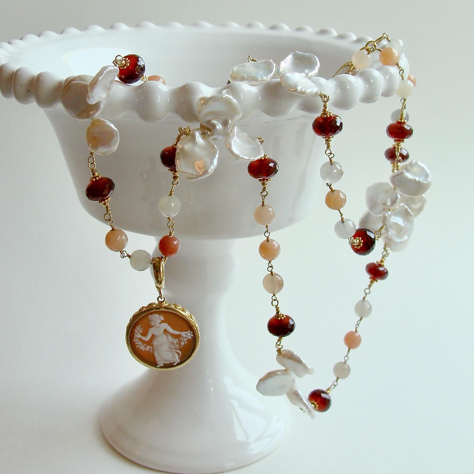 Elegant facet moonstone in colors ranging from white to peach and gray are intercepted with faceted hessonite garnet rondelles.  The colors found in the necklace repeat the colors also found in the removable bail sardonyx cameo pendant.  This