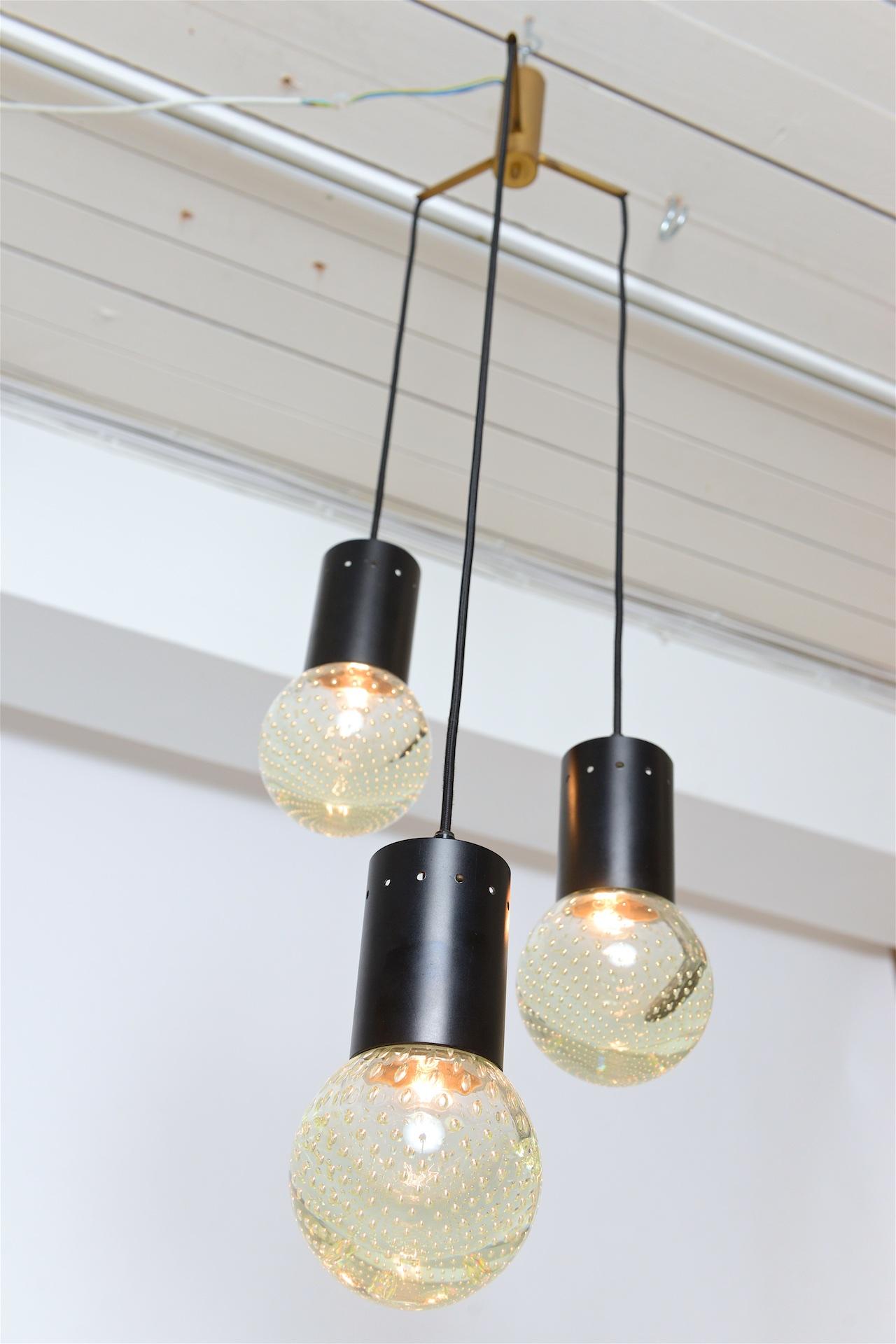 Chandelier with three glass globes. Lovely speckled light reflected through glass globes. 

Chandelier can be adjusted to any height.
