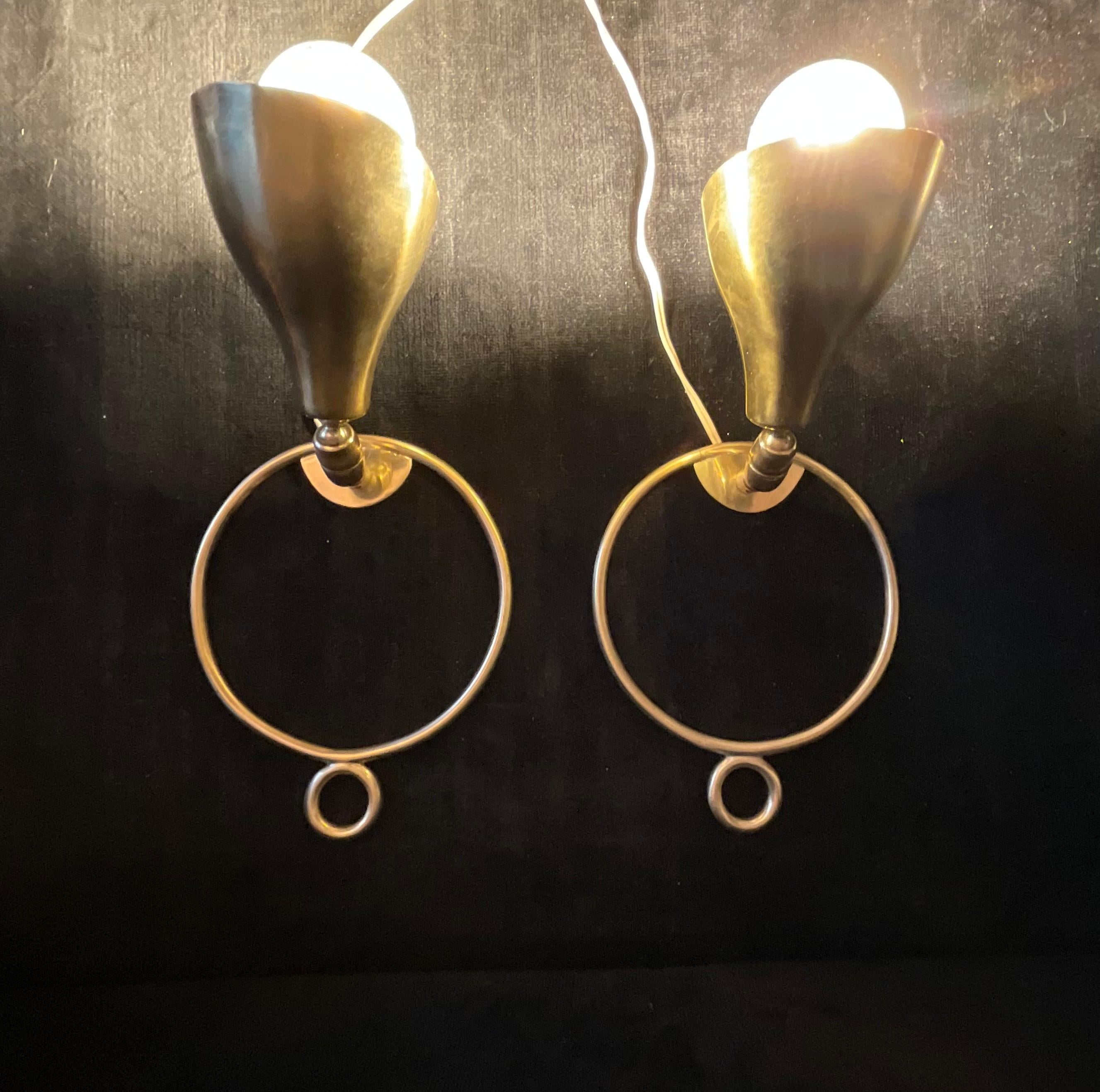 A very rare pair of wall sconces built in brass by the ARTELUCE company and designed by Italian entrepreneur and designer ,GINO SARFATTI in the late 1930s .
The pair of sconces is in perfect condition and in working order.