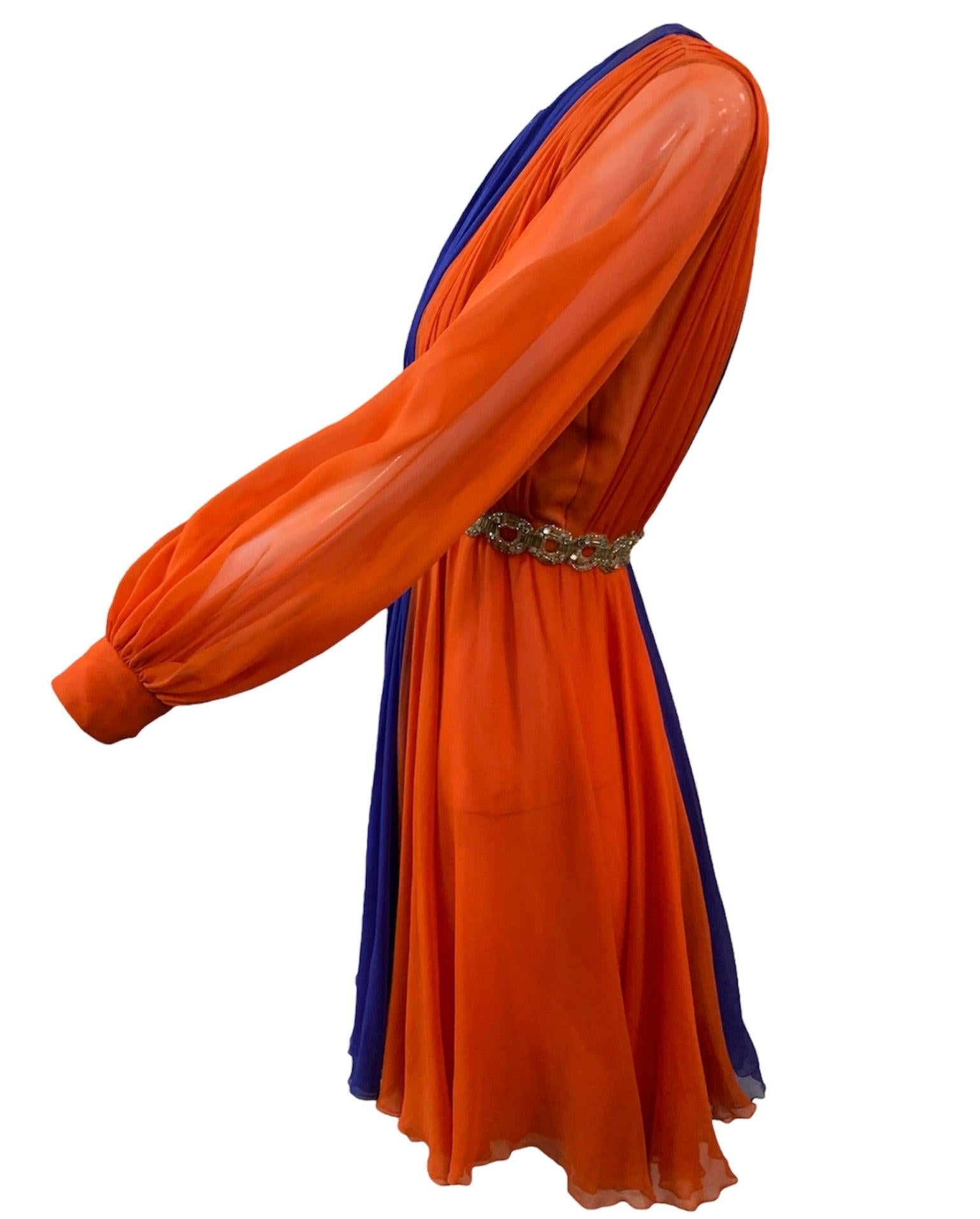 Darling and daring little party dress from Sarmi circa late 1960's. Panels of bright orange and violet blue chiffon gathered into a fit and flare style  with a slightly empire waistline. Slightly longer than a typical mini. Encircled at waist by
