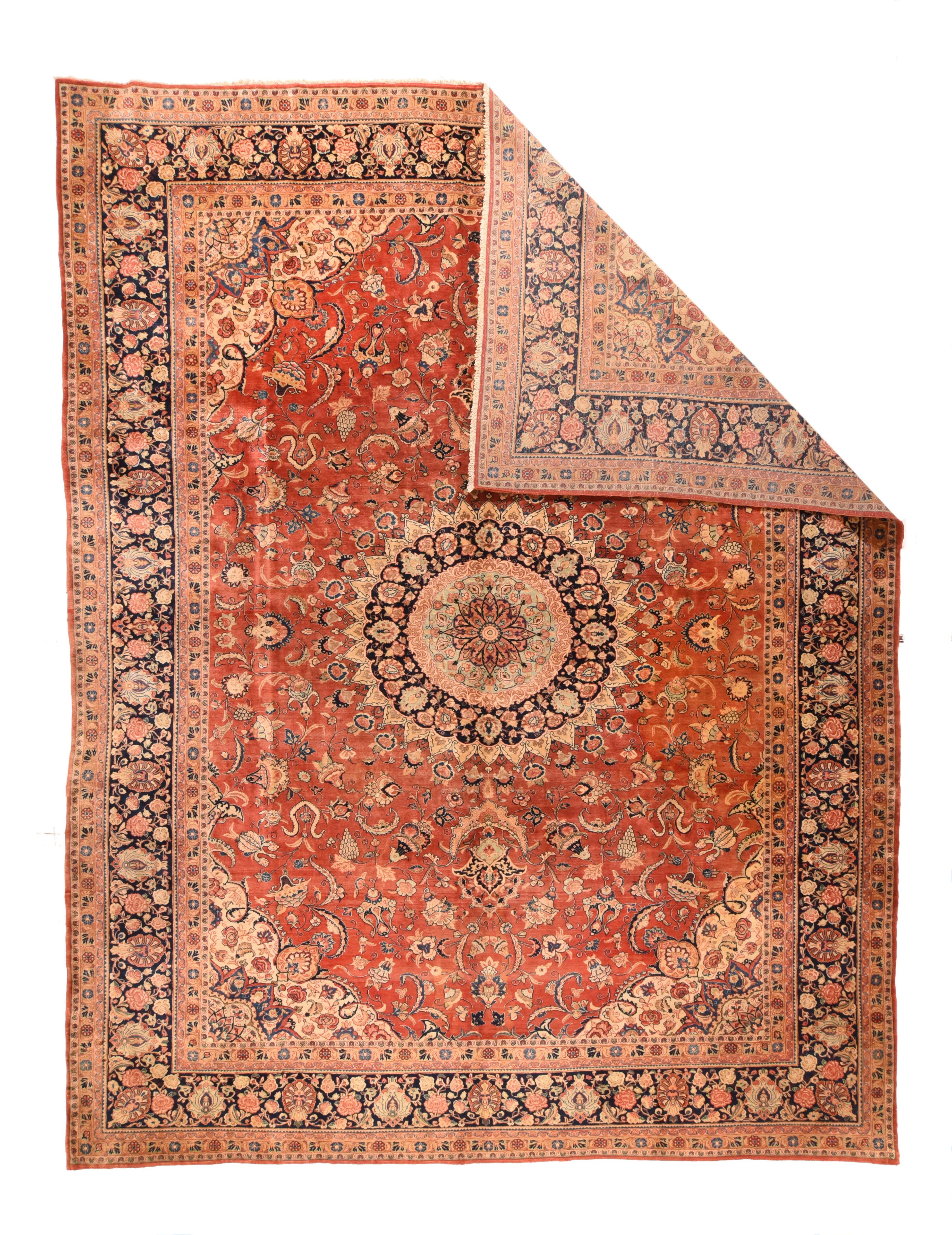 Although recent, this handsome west Persian village carpet shows antique traits in the 32 point, round nested near black medallion with palmette pendants; the warm red field with leaves, palmettes and cloud band blossoms. Ecru and near black