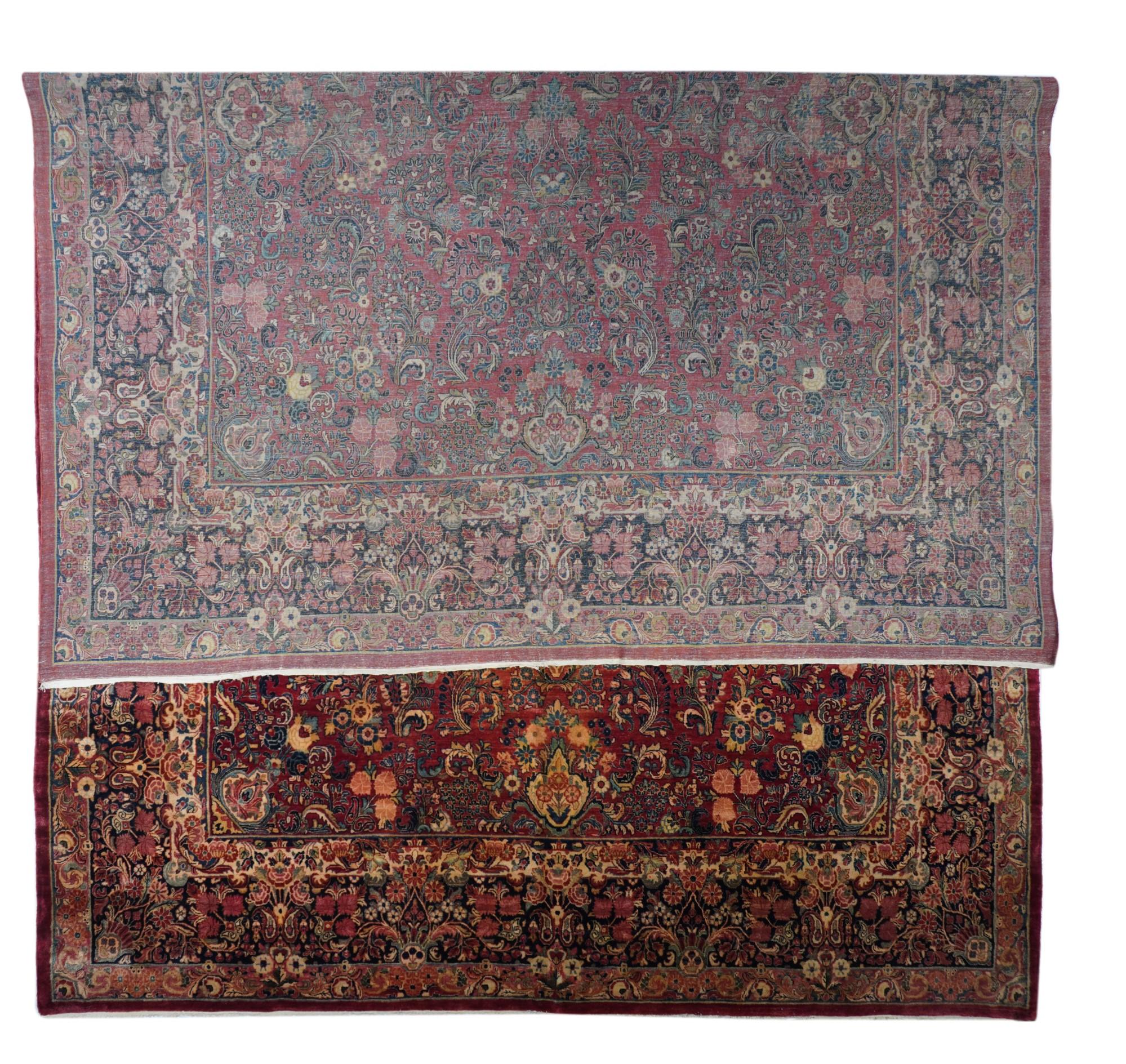 Vintage Sarouk Rug 12'0'' x 18'4''. This vintage west Persian large carpet shows a rich red field patterned with a myriad of small floating, detached floral sprays in cream, teal, light and dark blue and straw. The main navy border shows palmette