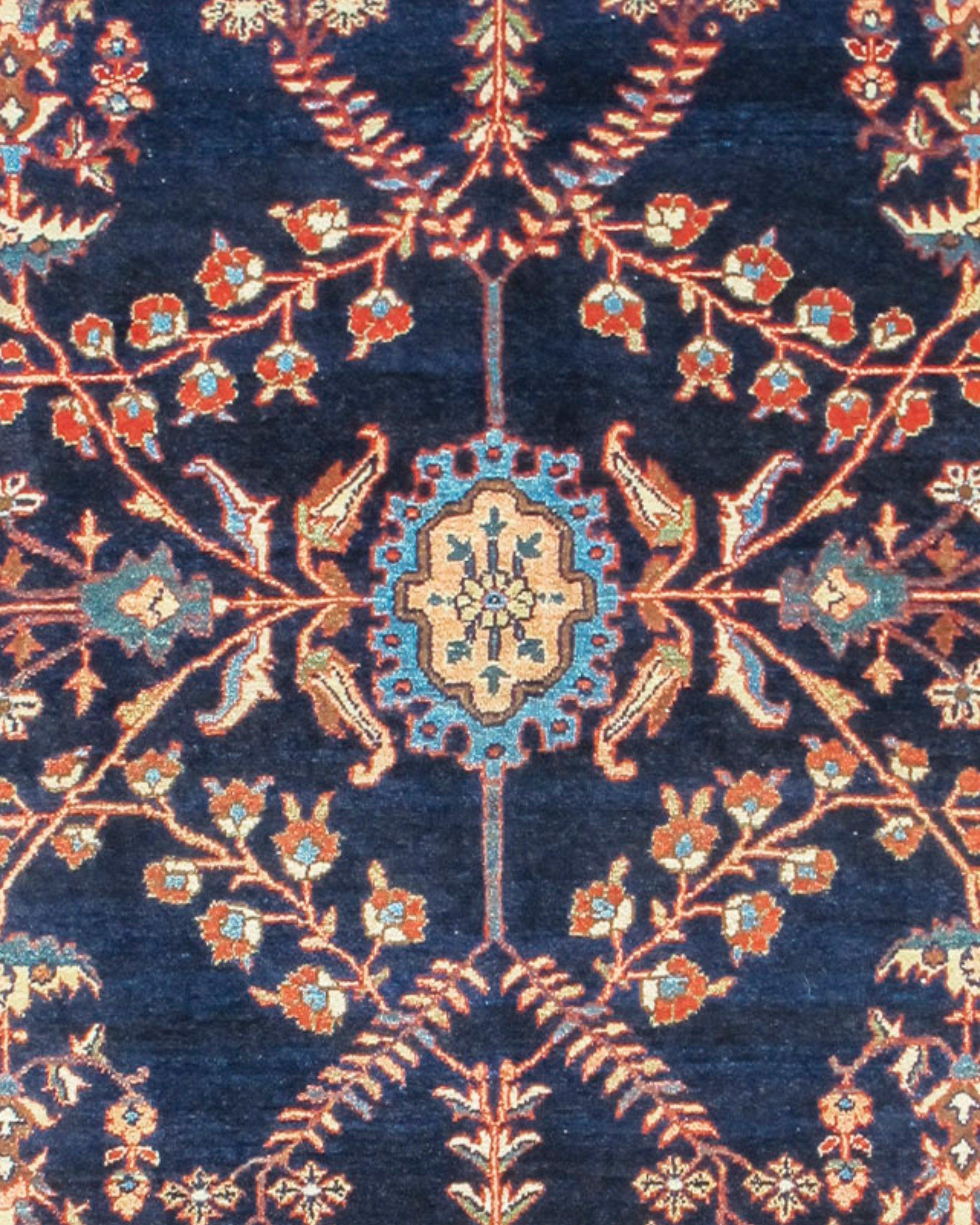Sarouk Rug, Early 20th Century

This refined antique Sarouk carpet from central Persia elegantly draws a variety of realistic and stylized garlands and flowering plants in a meandering network balanced around a small jewel-like medallion. Ornament