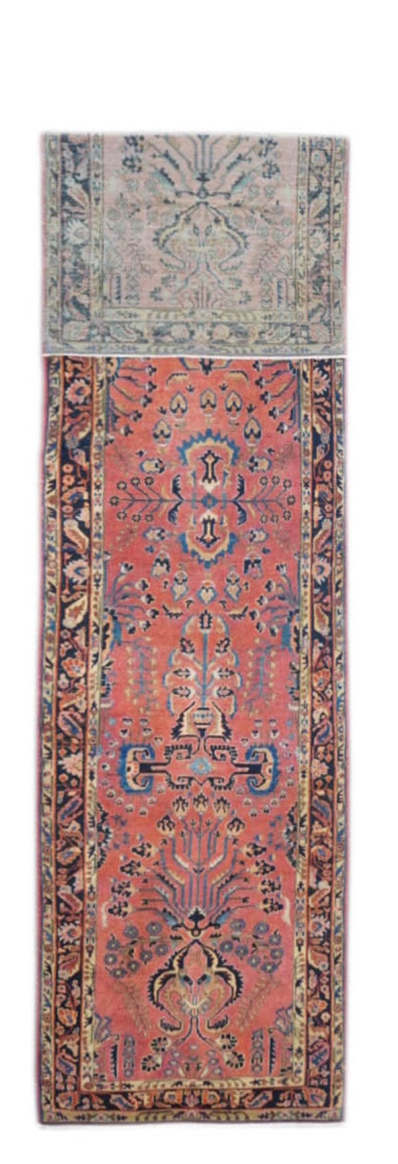 Sarouk Runner 2'8'' x 10'7''. The rose field is decorated by a detached floral pattern including two verdant, radiating blossom escutcheons, one at each end. 