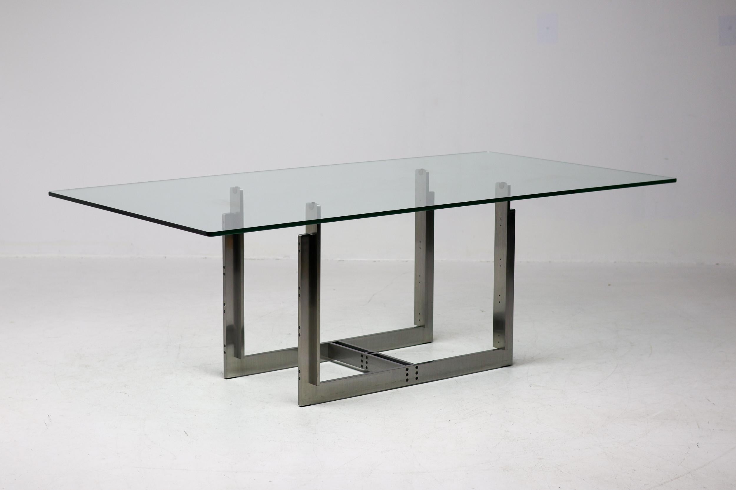 Mesa Sarpi diseñada por Carlo Scarpa para Simon Gavina con armazón de acero inoxidable cepillado, sujeto con tornillos empotrados visibles, Bolonia, Italia, 1970. Tablero de cristal con bordes redondeados, apoyado en el marco con goma insertada en