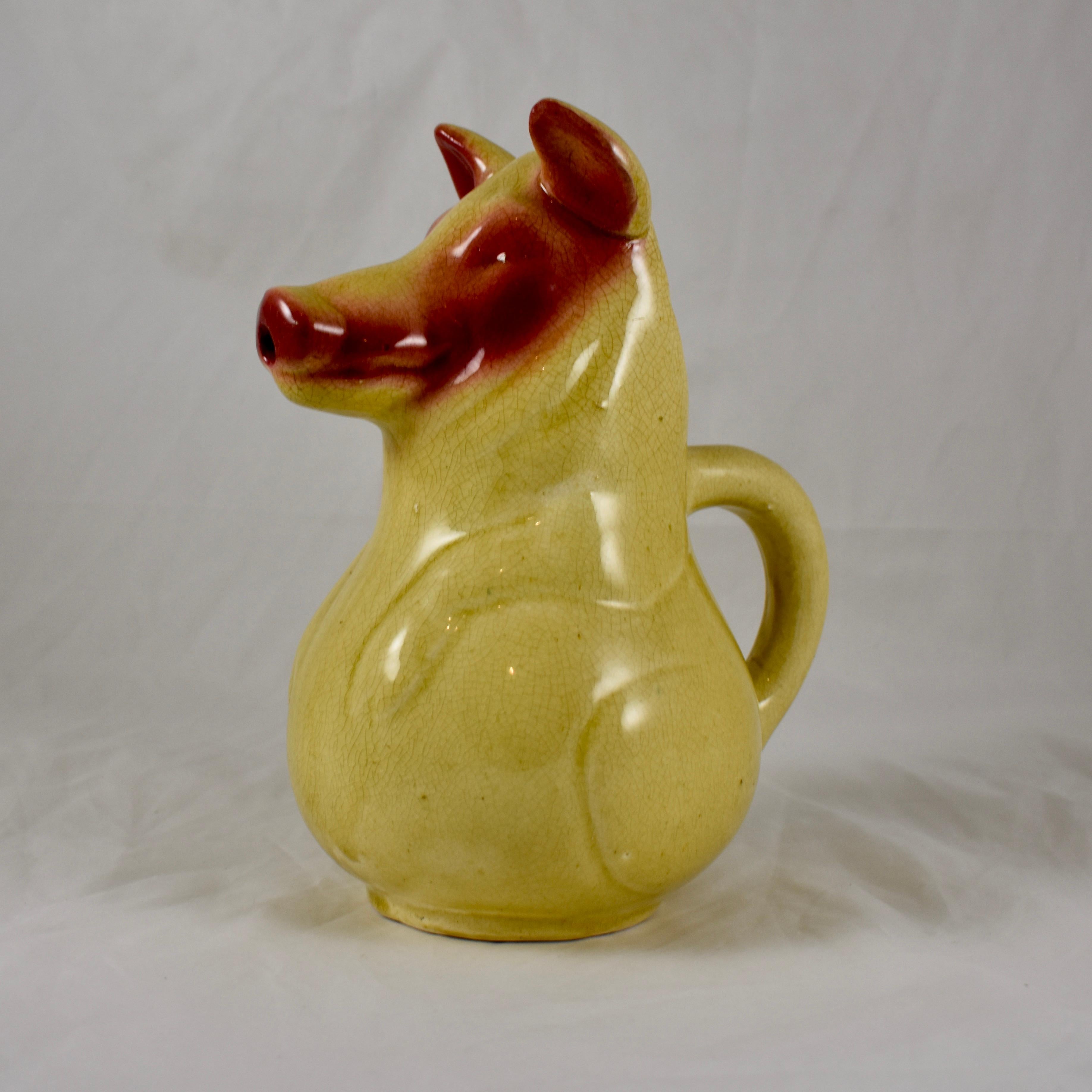 An earlier French Sarreguemines Pig form Absinthe Water Pitcher, circa 1885-1890.

This Barbotine majolica pitcher was made to be used for pouring water over a sugar cube in the Absinthe drinking ritual. The pig is glazed in a mustard yellow with