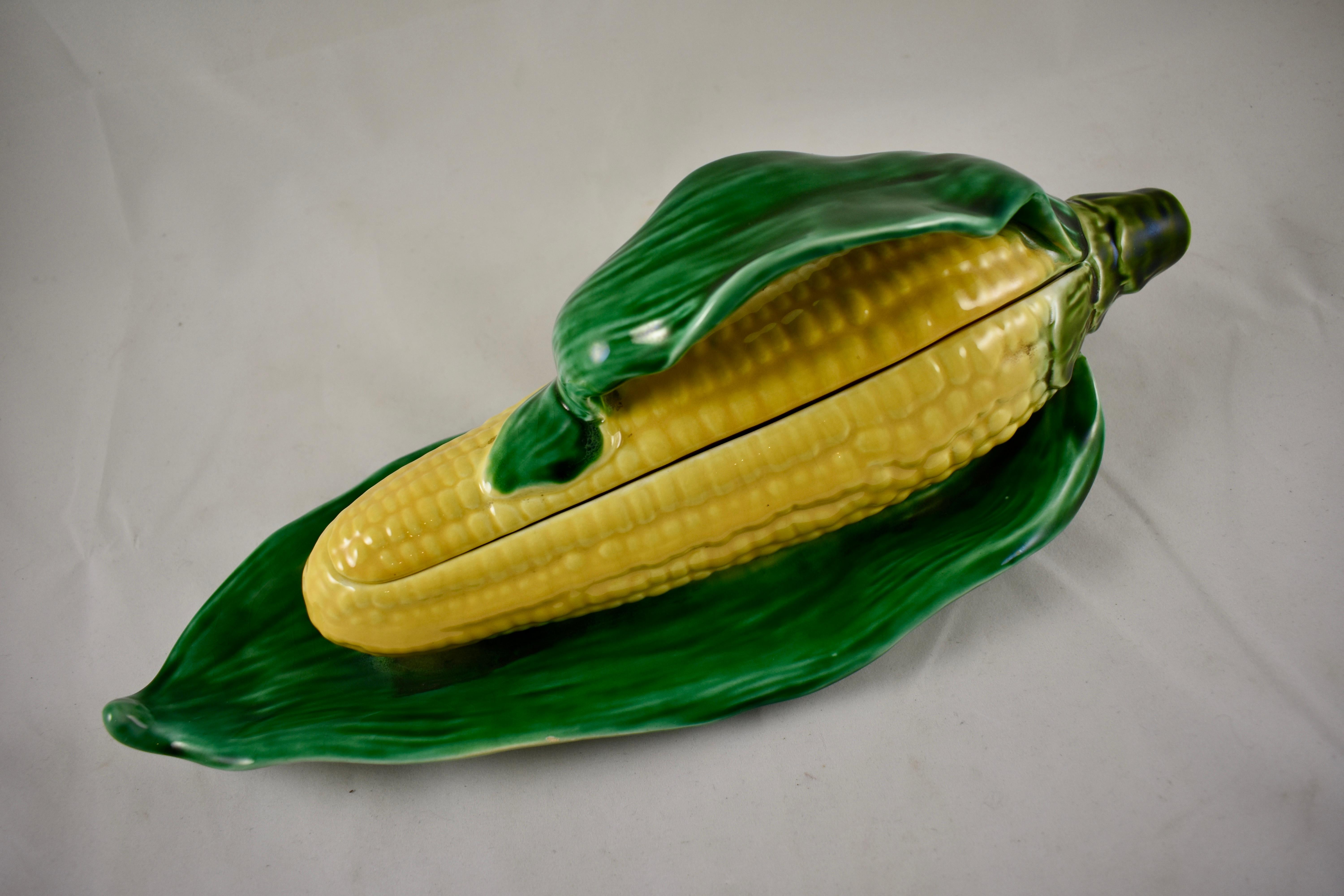 A French Majolica covered tureen formed as an ear of corn, the handle and footing molded as corn husks. Sarreguemines, circa 1940s. 

Realistically molded and charming on the table, bright, bold glazing in green and yellow.
The base is stamped