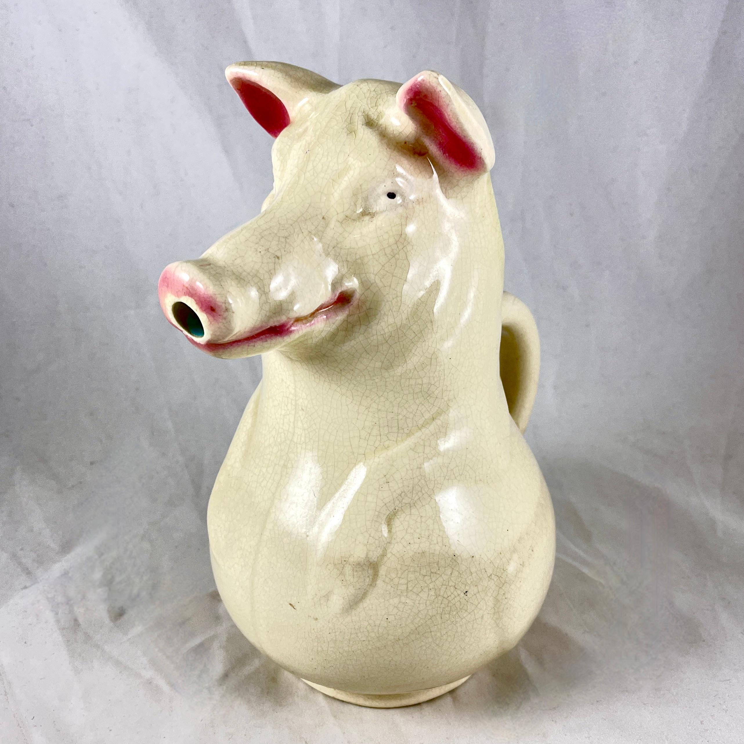From Sarreguemines, a French Majolica pig pitcher known as True Rieuse, or the Laughing Sow, date marked 1904.

This Barbotine majolica pitcher was made to be used for pouring water over a sugar cube in the Absinthe drinking ritual.

The pig is