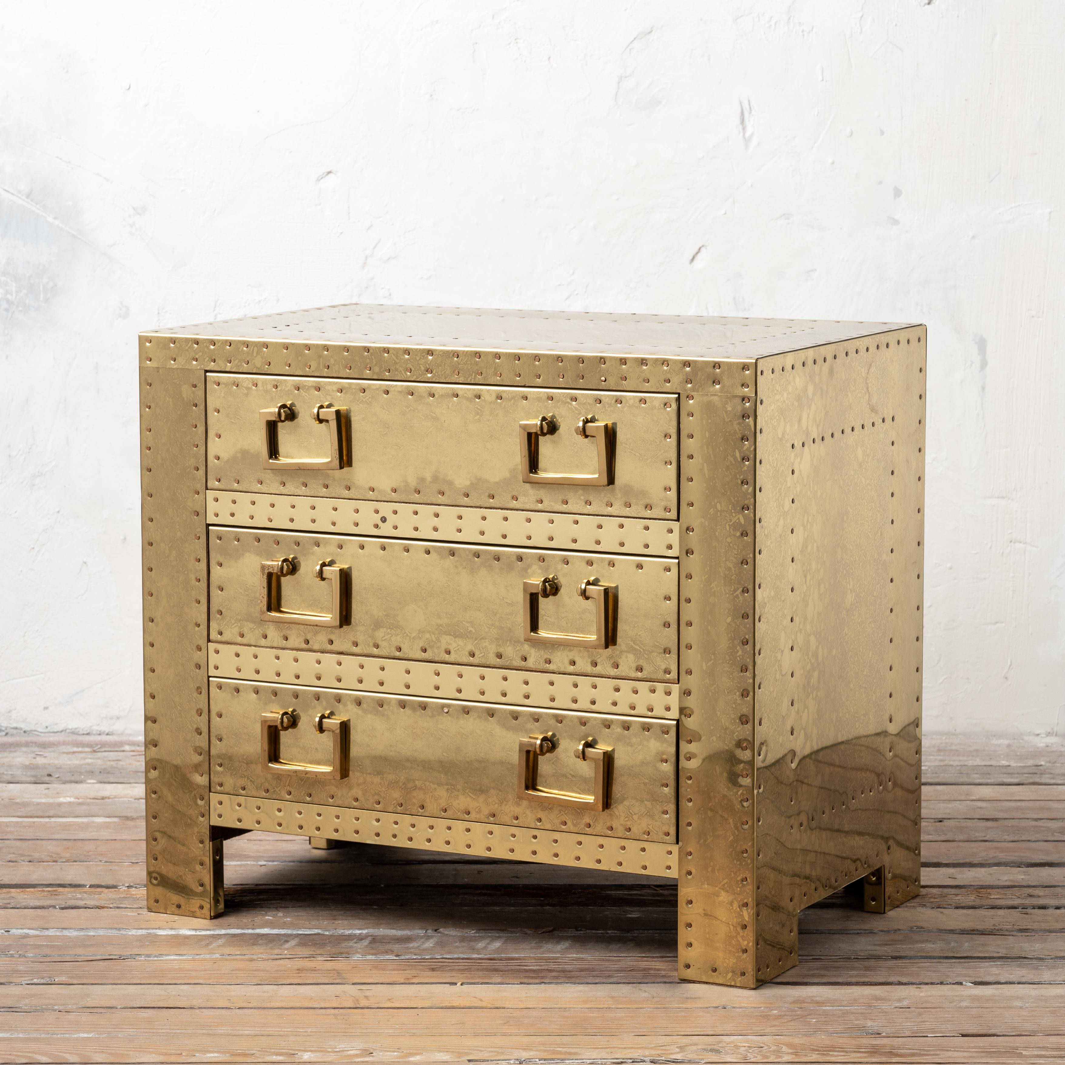 A Sarreid brass three drawer side chest, 1970s.

24 inches wide by 15 ½ inches deep by 21 ¼ inches
