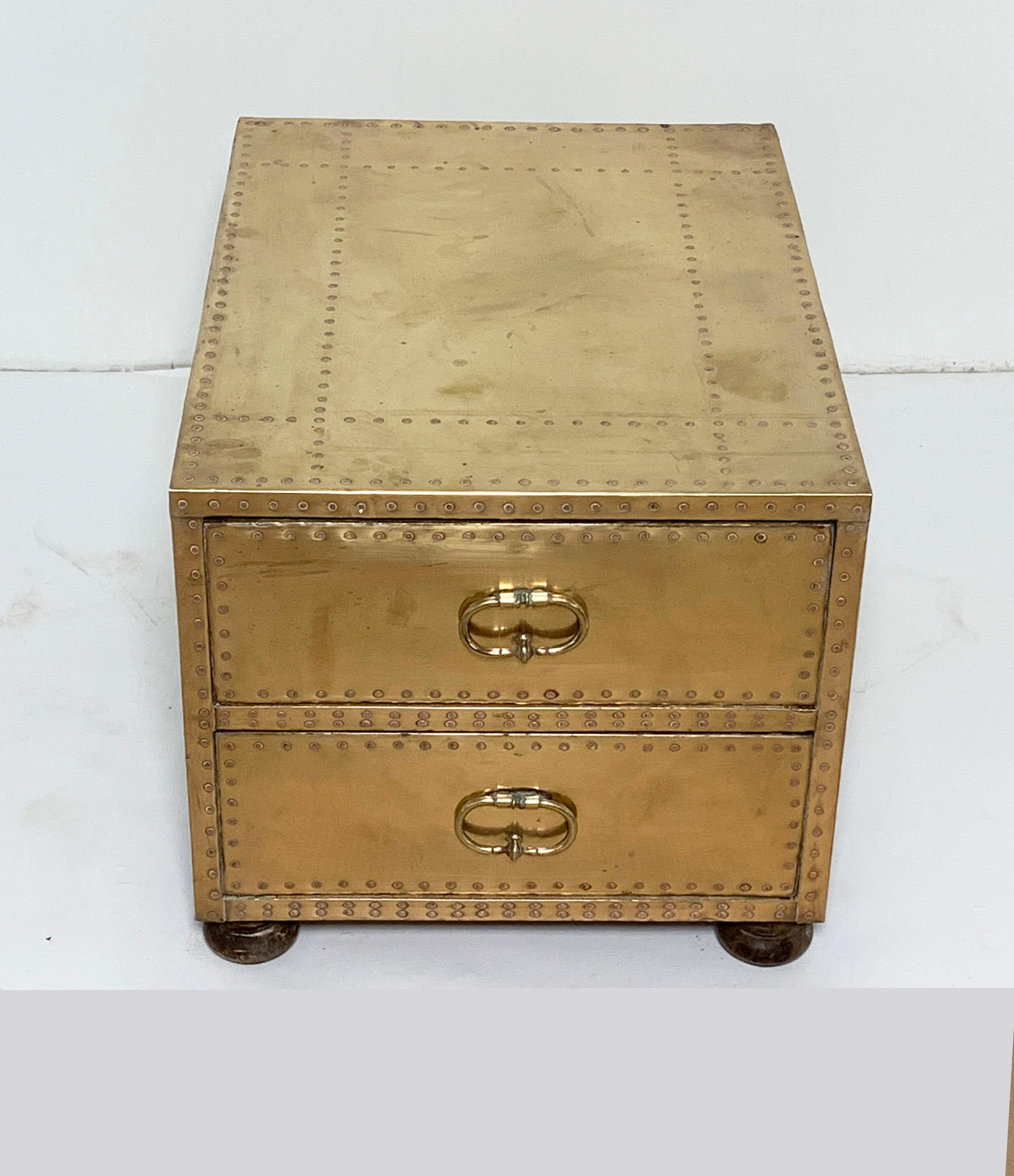 Brass clad cocktail table or side table in form of a chest with two drawers on bun feet by Sarreid Spain, circa 1970s. Oriented with drawers on the end.