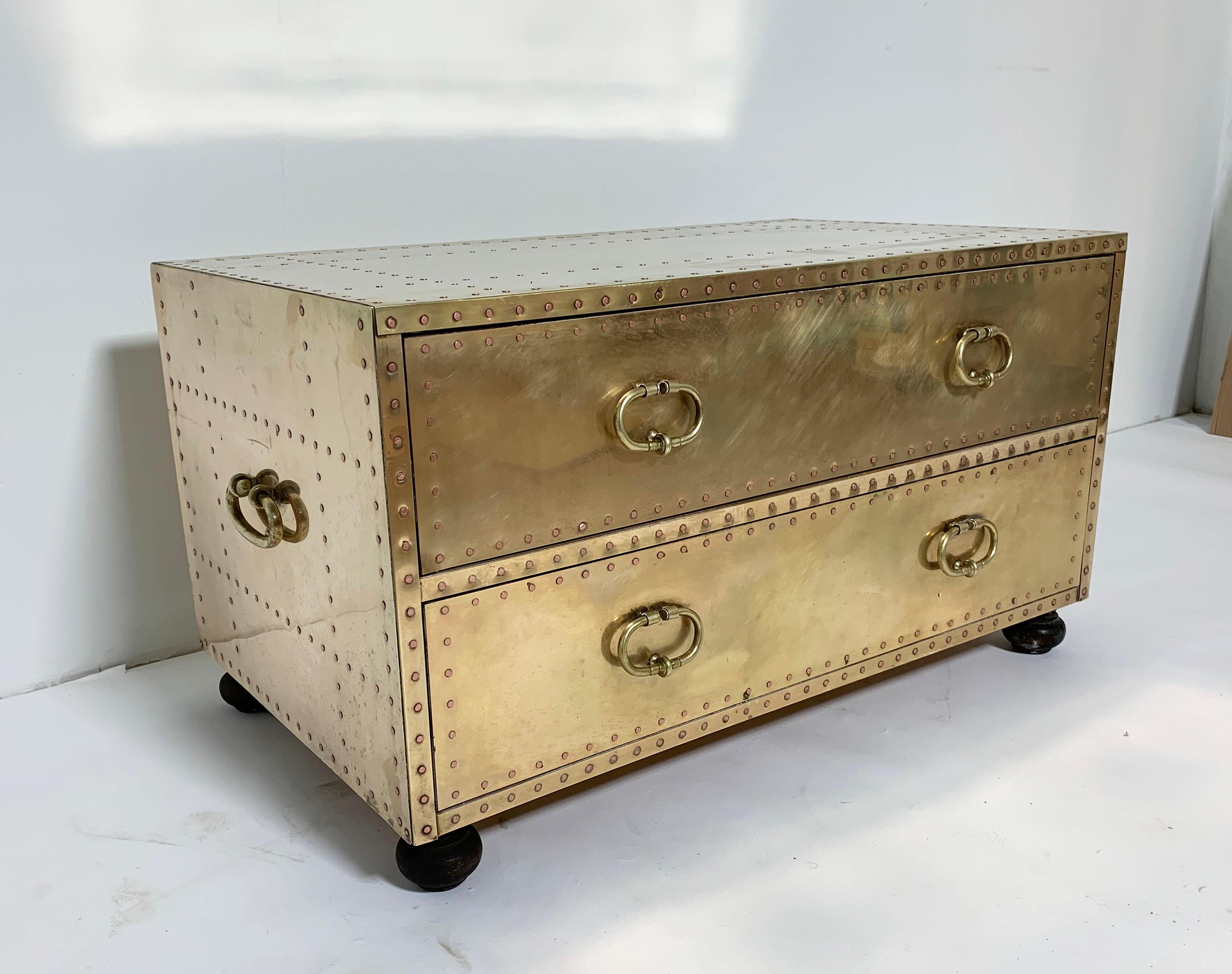 Brass clad cocktail table in form of a chest with two drawers on bun feet by Sarreid Spain, circa 1970s.